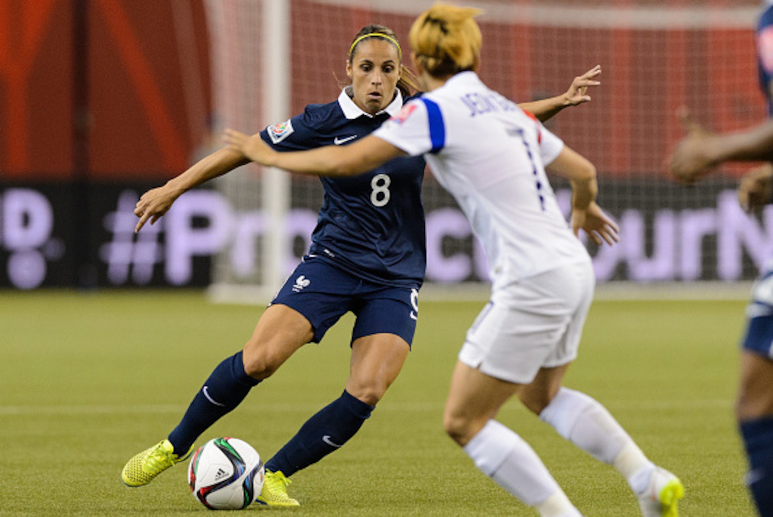 MONTREAL, QC - JUNE 21:  Jessica Houara #8 of France tries to move the ball past Jeon Gaeul #7 of Korea Republic during the 2015 FIFA Women's World Cup Round of 16 match at Olympic Stadium on June 21, 2015 in Montreal, Quebec, Canada.  France defeated Kor