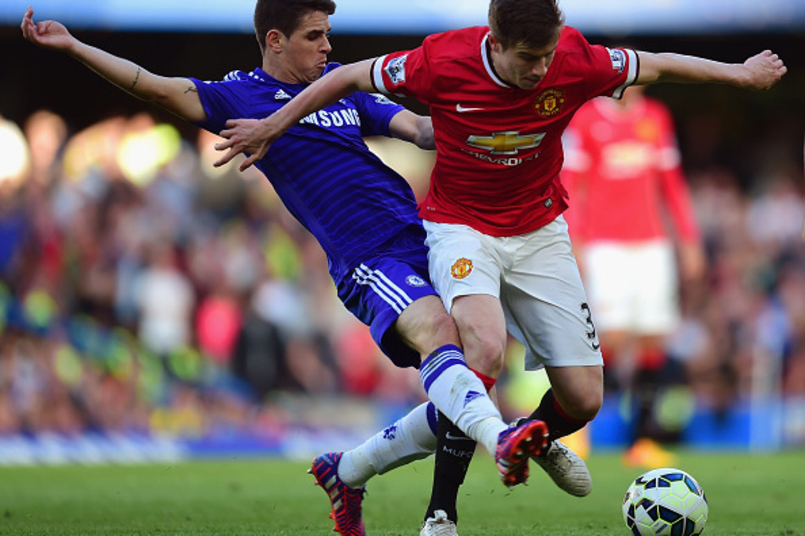 LONDON, ENGLAND - APRIL 18:  Oscar of Chelsea tackles Paddy McNair of Manchester United  during the Barclays Premier League match between Chelsea and Manchester United at Stamford Bridge on April 18, 2015 in London, England.  (Photo by Jamie McDonald/Gett