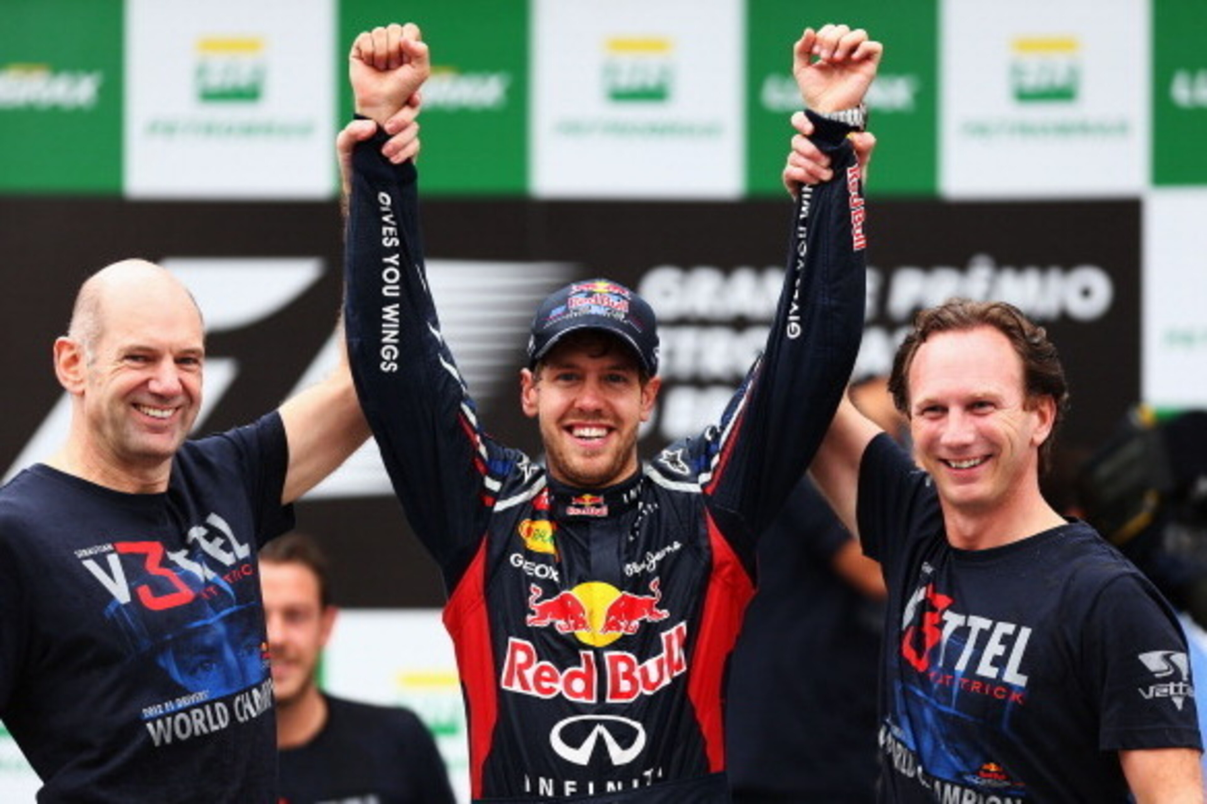 SAO PAULO, BRAZIL - NOVEMBER 25:  Sebastian Vettel (C) of Germany and Red Bull Racing celebrates with Red Bull Racing Chief Technical Officer Adrian Newey (L) and Team Principal Christian Horner (R) on the podium as he finishes in sixth position and clinc