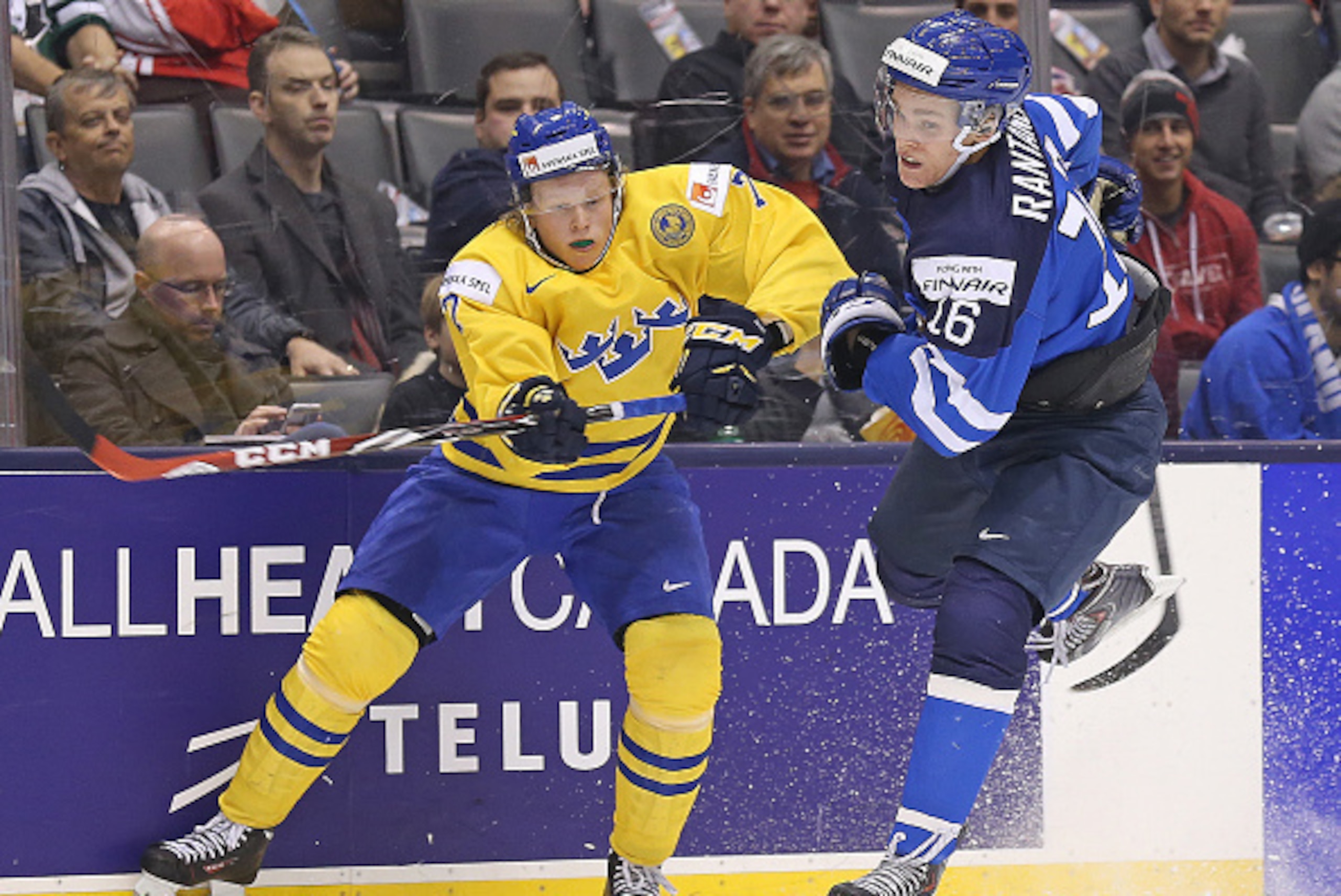 TORONTO, ON -JANUARY 2:  Julius Bergman #7 of Team Sweden slams into Mikko Rantanen #16 of Team Finland during a quarter-final game in the 2015 IIHF World Junior hockey championship at the Air Canada Centre on January 2, 2015 in Toronto, Ontario, Canada. 