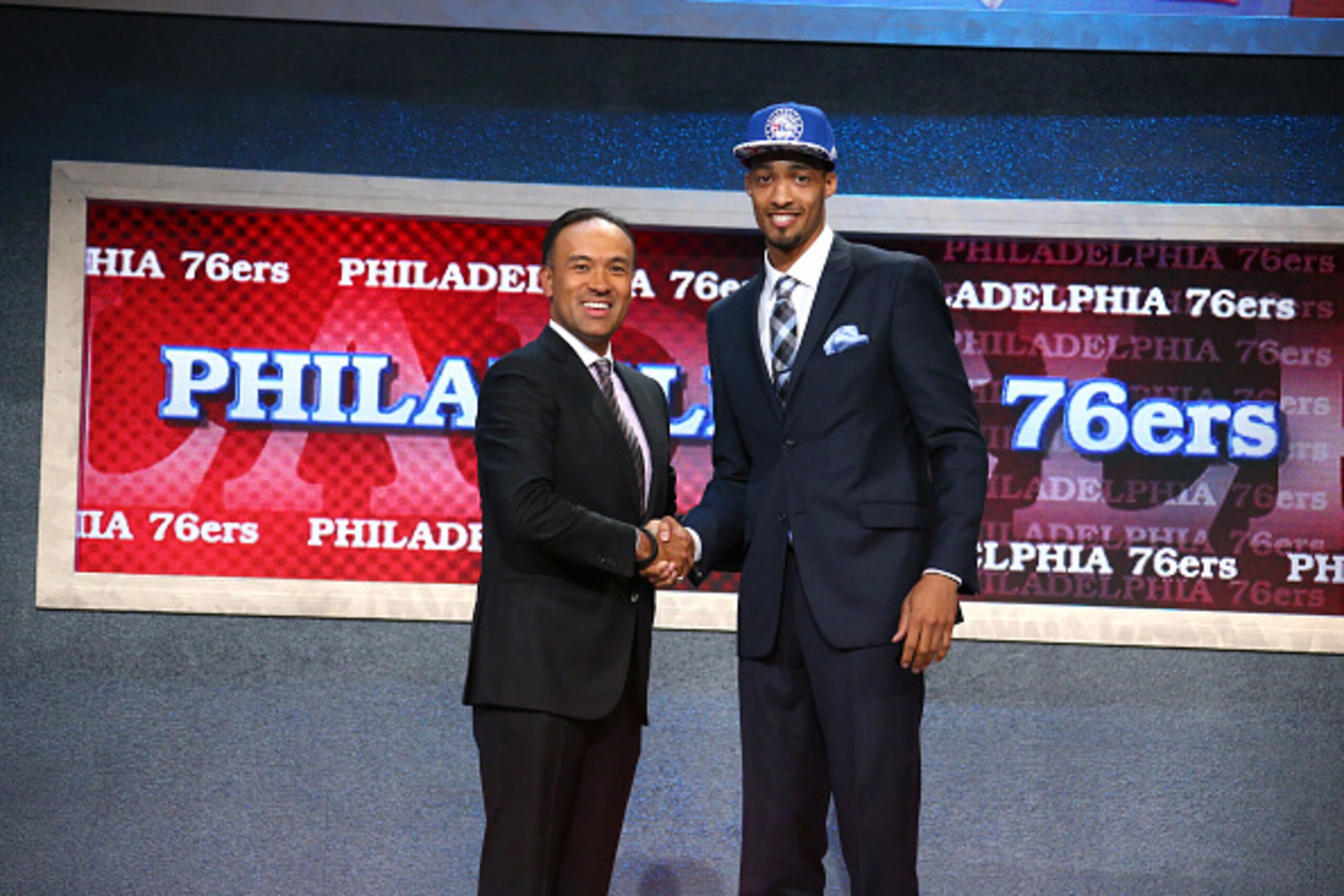 BROOKLYN, NY - JUNE 25: J.P. Tokoto shakes hands with Deputy Commissioner and Chief Operating Officer of the National Basketball Association, Mark Tatum after being selected number fifty eighth overall by the Philadelphia 76ers during the 2015 NBA Draft o BROOKLYN, NY - JUNE 25: J.P. Tokoto shakes hands with Deputy Commissioner and Chief Operating Officer of the National Basketball Association, Mark Tatum after being selected number fifty eighth overall by the Philadelphia 76ers during the 2015 NBA Draft o