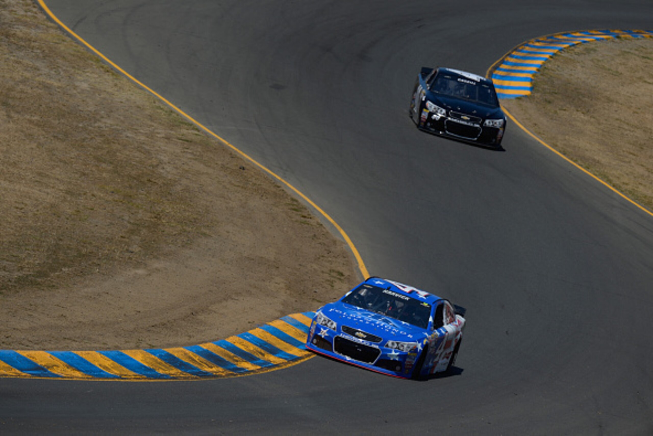 SONOMA, CA - JUNE 26:  Kevin Harvick, driver of the #4 FoldsofHonor/OutbackSteakhouse/Budweiser Chevrolet, and Landon Cassill, driver of the #40 Chevrolet, practice for the NASCAR Sprint Cup Series Toyota/Save Mart 350 at Sonoma Raceway on June 26, 2015 i