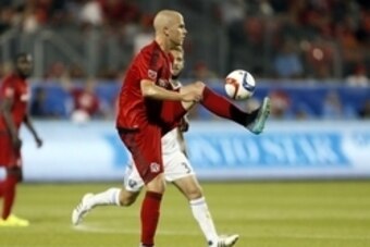 Jun 24, 2015; Toronto, Ontario, CAN; Toronto FC midfielder Michael Bradley (4) goes to kick the ball against the Montreal Impact at BMO Field. Toronto defeated Montreal 3-1. Mandatory Credit: John E. Sokolowski-USA TODAY Sports