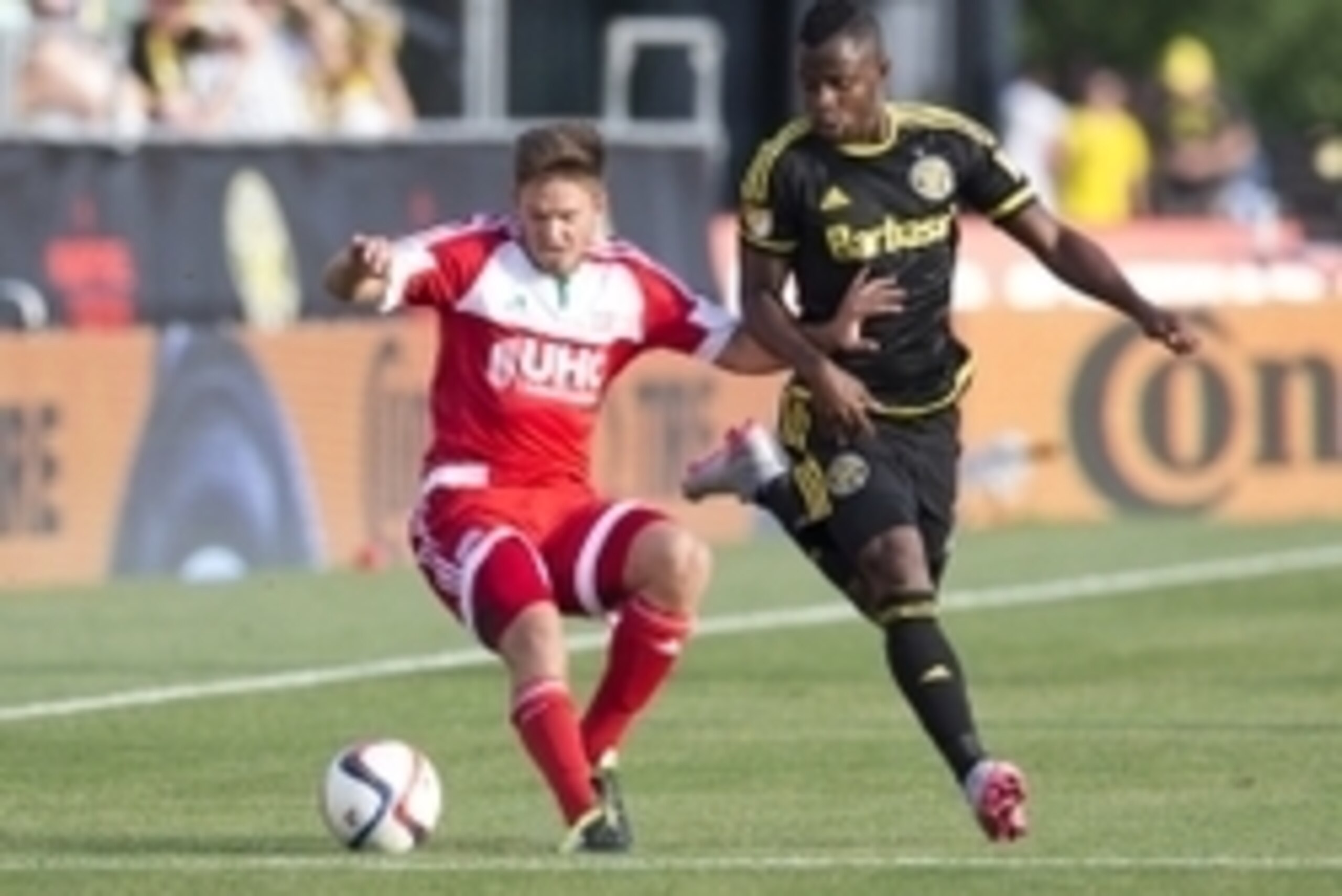 Jun 24, 2015; Columbus, OH, USA; New England Revolution midfielder Kelyn Rowe (11) tries to keep Columbus Crew SC defender Waylon Francis (14) off the ball at MAPFRE Stadium. Mandatory Credit: Greg Bartram-USA TODAY Sports