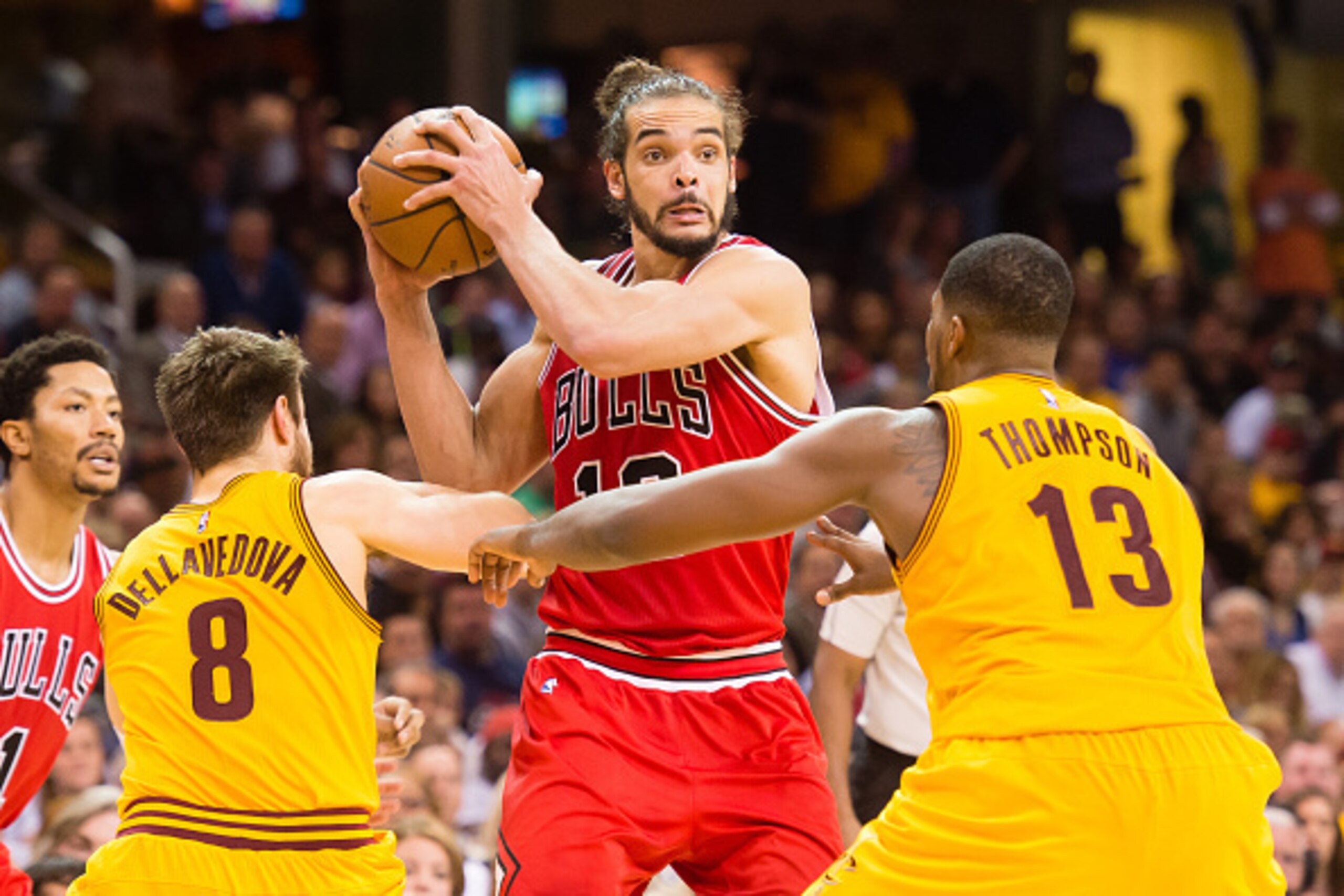 CLEVELAND, OH - MAY 12: Joakim Noah #13 of the Chicago Bulls looks for a pass while under pressure from Matthew Dellavedova #8 and Tristan Thompson #13 of the Cleveland Cavaliers in the second half during Game Five in the Eastern Conference Semifinals of 
