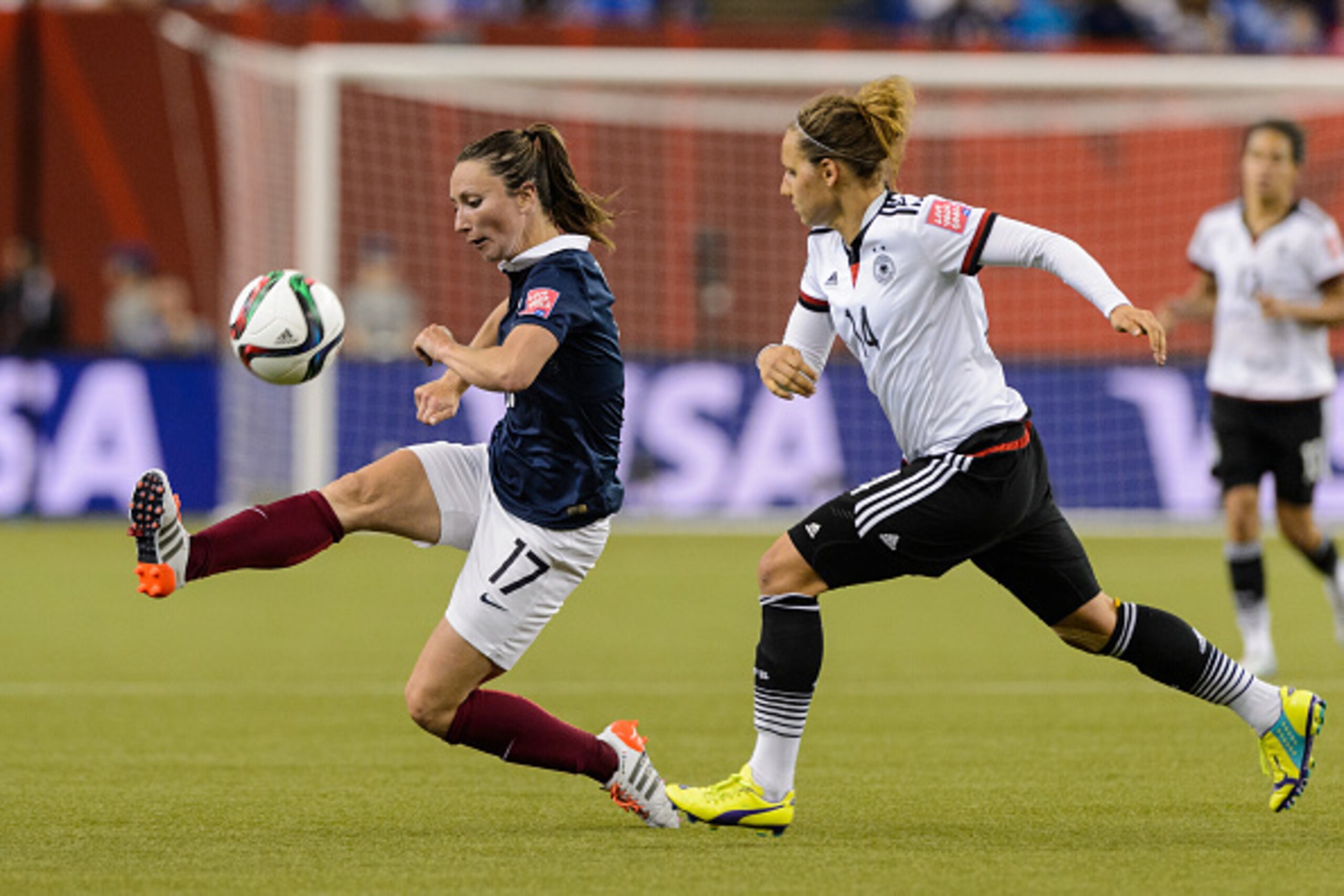 MONTREAL, QC - JUNE 26: Gaetane Thiney #17 of France plays the ball with Babett Peter #14 of Germany following close behind during the 2015 FIFA Women's World Cup quarter final match at Olympic Stadium on June 26, 2015 in Montreal, Quebec, Canada. Germany