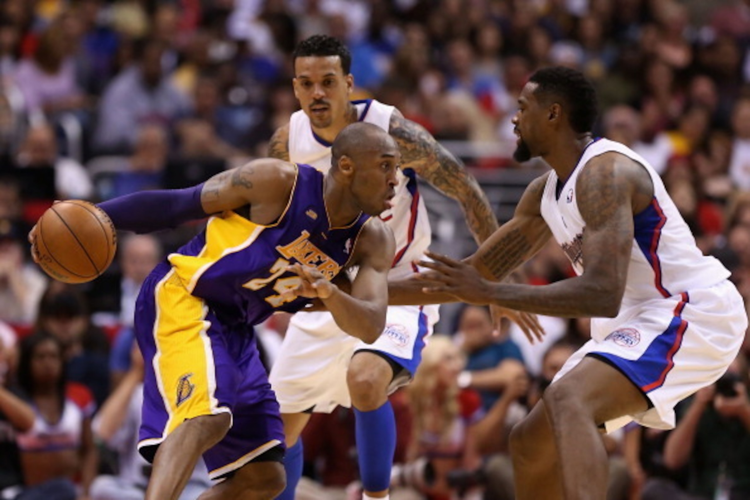 LOS ANGELES, CA - APRIL 07:  Kobe Bryant #24 of the Los Angeles Lakers handles the ball guarded by Matt Barnes #22 and DeAndre Jordan #6 of the Los Angeles Clippers during the second half of the NBA game at Staples Center on April 7, 2013 in Los Angeles, 