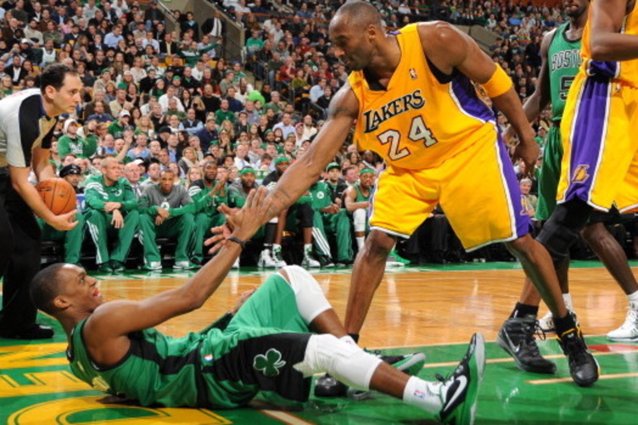 BOSTON, MA - FEBRUARY 9: Kobe Bryant #24 of the Los Angeles Lakers helps up Rajon Rondo #9 of the Boston Celtics on February 9, 2012 at the TD Garden in Boston, Massachusetts. NOTE TO USER: User expressly acknowledges and agrees that, by downloading and o