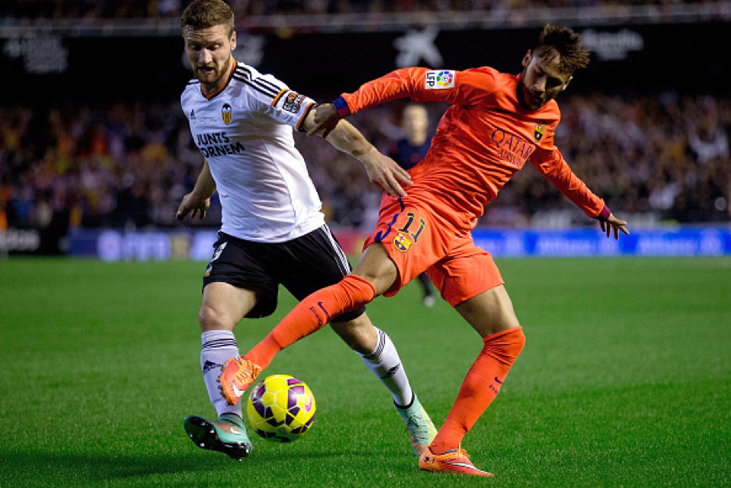 VALENCIA, SPAIN - NOVEMBER 30: Shkodran Mustafi (L) of Valencia CF competes for the ball with Neymar JR. (R) of FC Barcelona   during the La Liga match between Valencia CF and FC Barcelona at Estadi de Mestalla on November 30, 2014 in Valencia, Spain.  (P