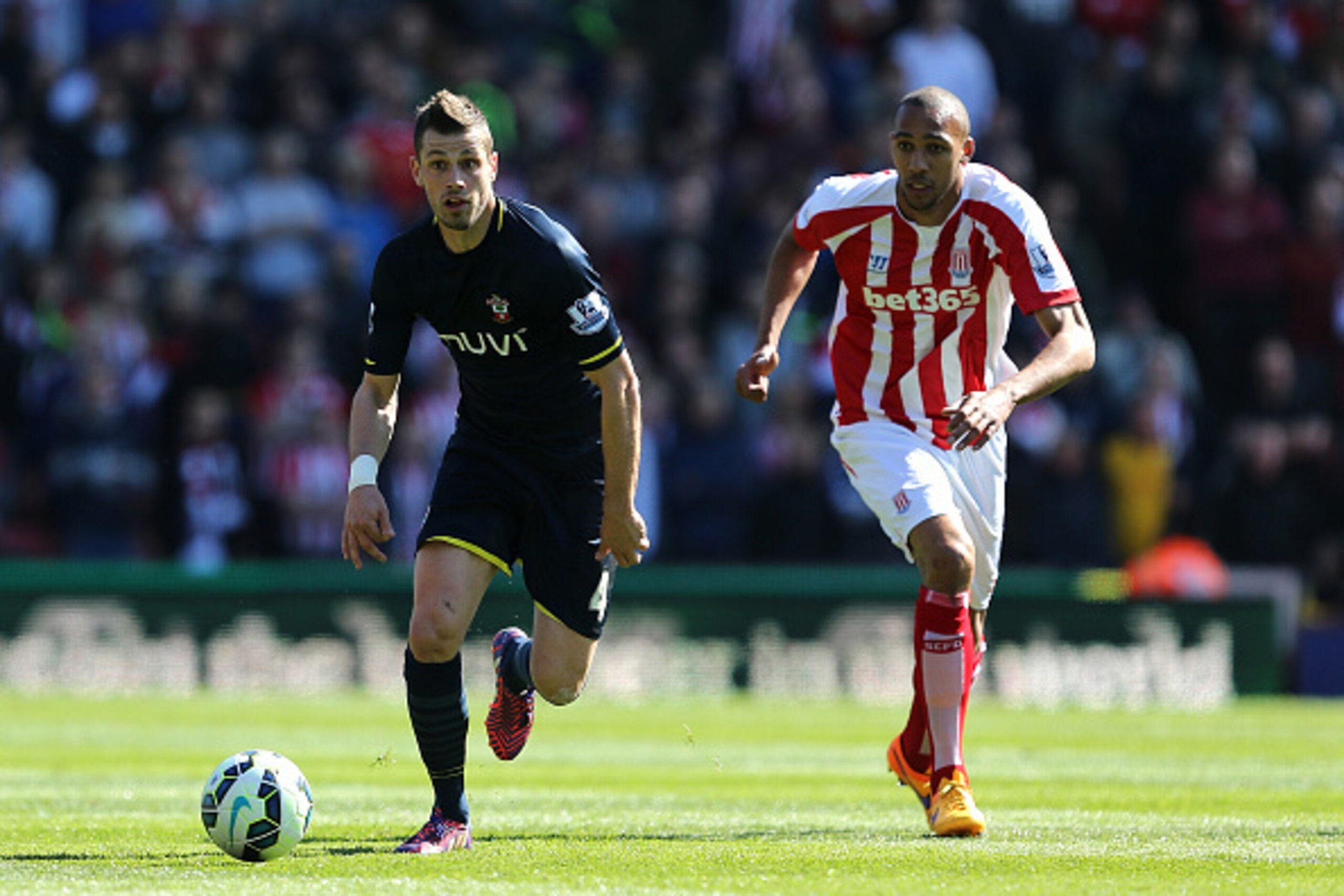 STOKE ON TRENT, ENGLAND - APRIL 18: Morgan Schneiderlin of Southampton competes with Steven Nzonzi of Stoke during the Barclays Premier League match between Stoke City and Southampton at the Britannia Stadium on April 18, 2015 in Stoke on Trent, England. STOKE ON TRENT, ENGLAND - APRIL 18: Morgan Schneiderlin of Southampton competes with Steven Nzonzi of Stoke during the Barclays Premier League match between Stoke City and Southampton at the Britannia Stadium on April 18, 2015 in Stoke on Trent, England.