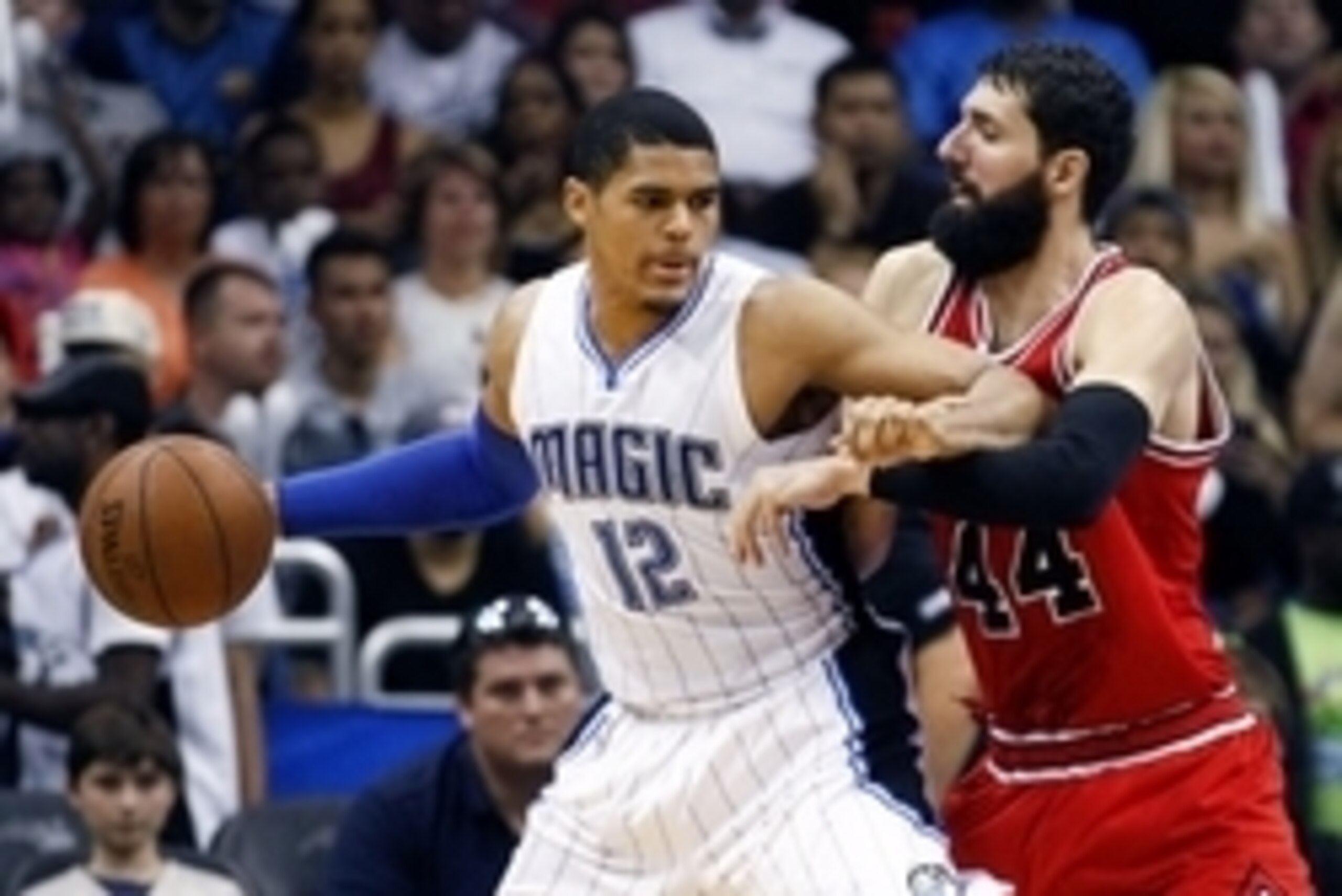Apr 8, 2015; Orlando, FL, USA; Orlando Magic forward Tobias Harris (12) pushes back against Chicago Bulls forward Nikola Mirotic (44) during the second half at Amway Center. The Magic won 105-103. Mandatory Credit: Reinhold Matay-USA TODAY Sports