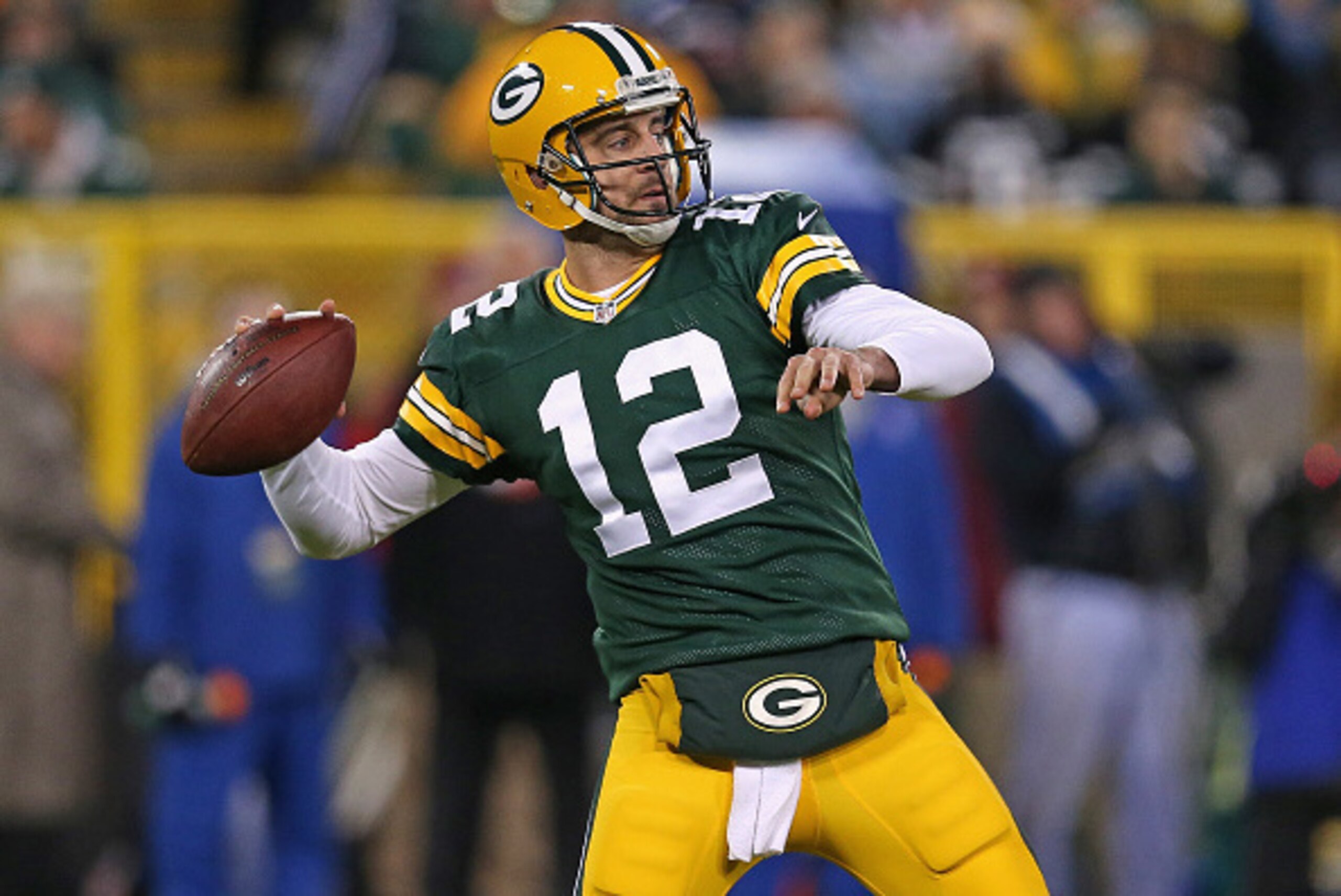 GREEN BAY, WI - NOVEMBER 09: Quarterback  Aaron Rodgers #12 of the Green Bay Packers throws a 56 yard touchdown in the second quarter against the Chicago Bears at Lambeau Field on November 9, 2014 in Green Bay, Wisconsin. (Photo by Jonathan Daniel/Getty I