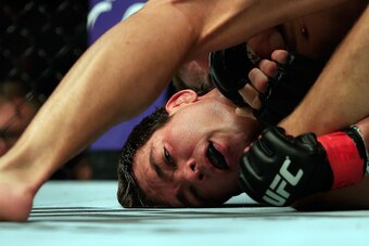 NEWARK, NJ - APRIL 18:  Luke Rockhold and Lyoto Machida of Brazil grapple in their middleweight bout during the UFC Fight Night event at Prudential Center on April 18, 2015 in Newark, New Jersey.  (Photo by Alex Trautwig/Getty Images)