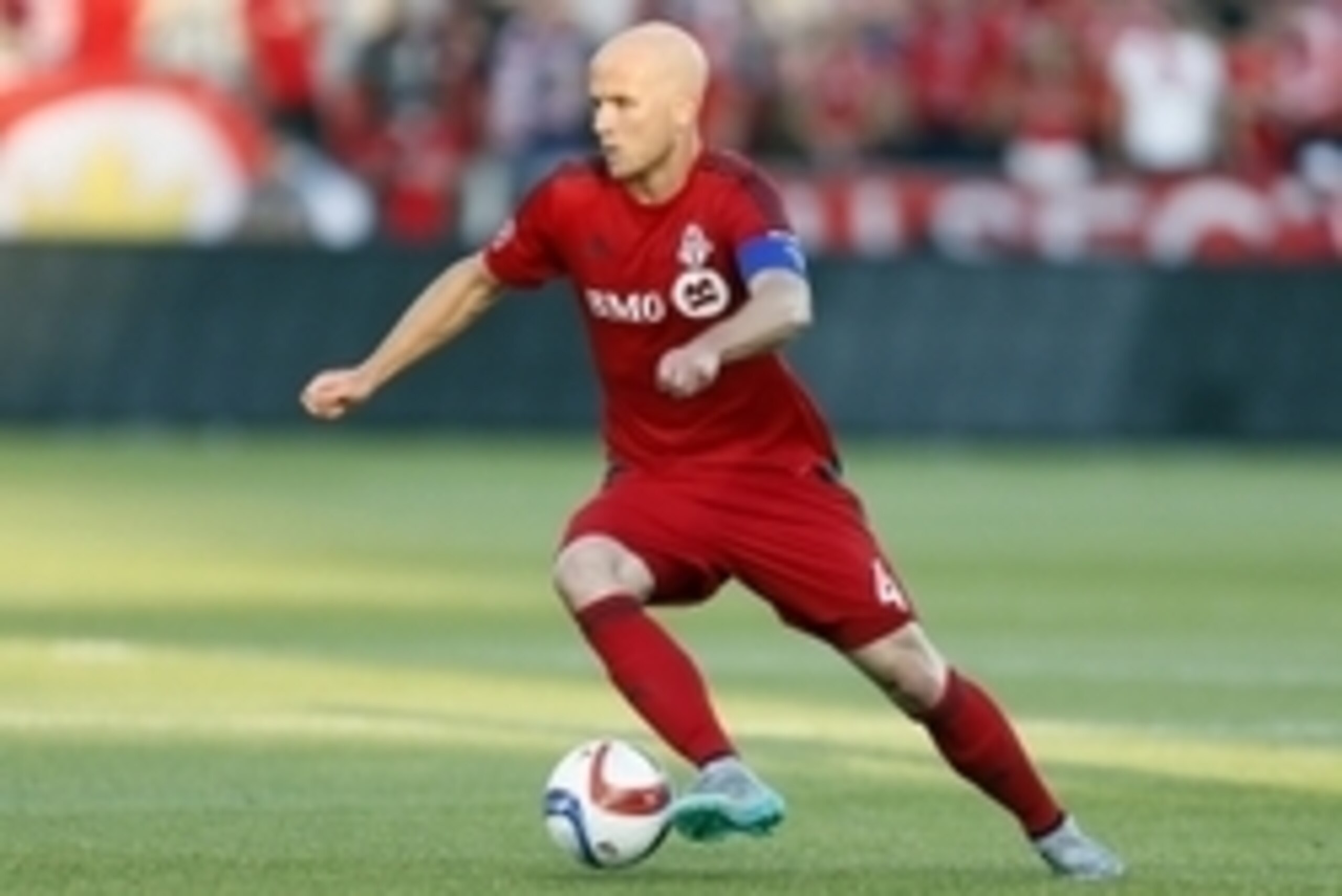 Jun 24, 2015; Toronto, Ontario, CAN; Toronto FC midfielder Michael Bradley (4) carries the ball against the Montreal Impact at BMO Field. Toronto defeated Montreal 3-1. Mandatory Credit: John E. Sokolowski-USA TODAY Sports