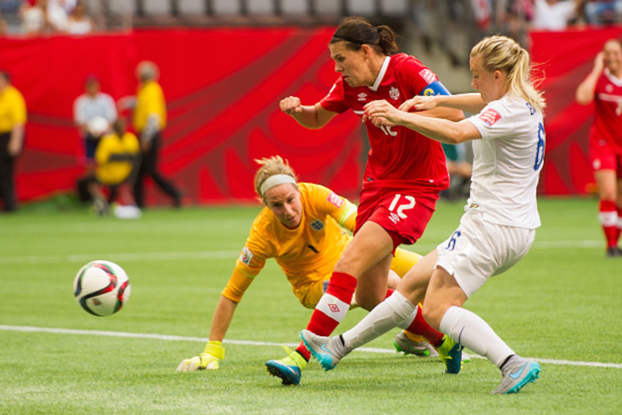 VANCOUVER, BC - JUNE 27: Christine Sinclair #12 of Canada shoots the ball past goalkeeper Karen Bardsley #1 of England for a goal during the FIFA Women's World Cup Canada 2015 Quarter Final match between the England and Canada June, 27, 2015 at BC Place S