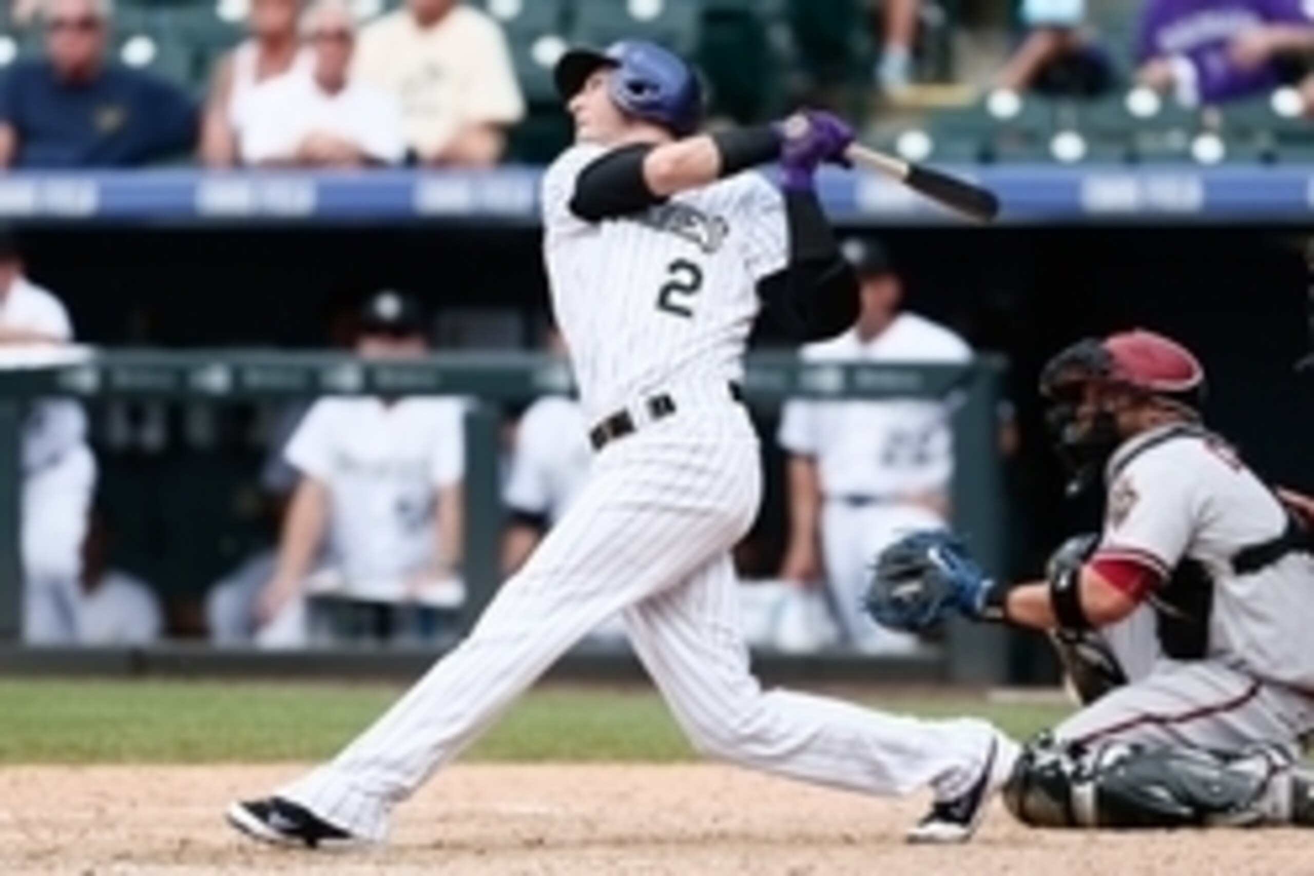 Jun 25, 2015; Denver, CO, USA; Colorado Rockies shortstop Troy Tulowitzki (2) hits a one run home run in the eighth inning against the Arizona Diamondbacks at Coors Field. The Rockies defeated the Diamondbacks 6-4. Mandatory Credit: Isaiah J. Downing-USA 