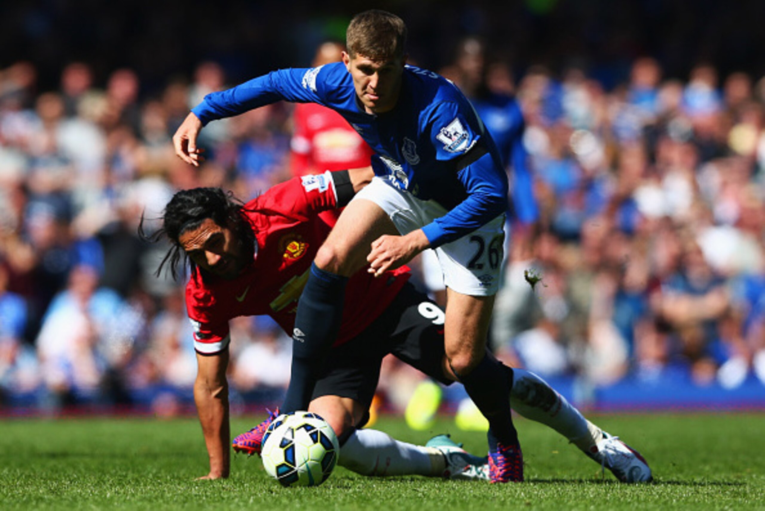 LIVERPOOL, ENGLAND - APRIL 26:  John Stones of Everton battles with Radamel Falcao Garcia of Manchester United during the Barclays Premier League match between Everton and Manchester United at Goodison Park on April 26, 2015 in Liverpool, England.  (Photo