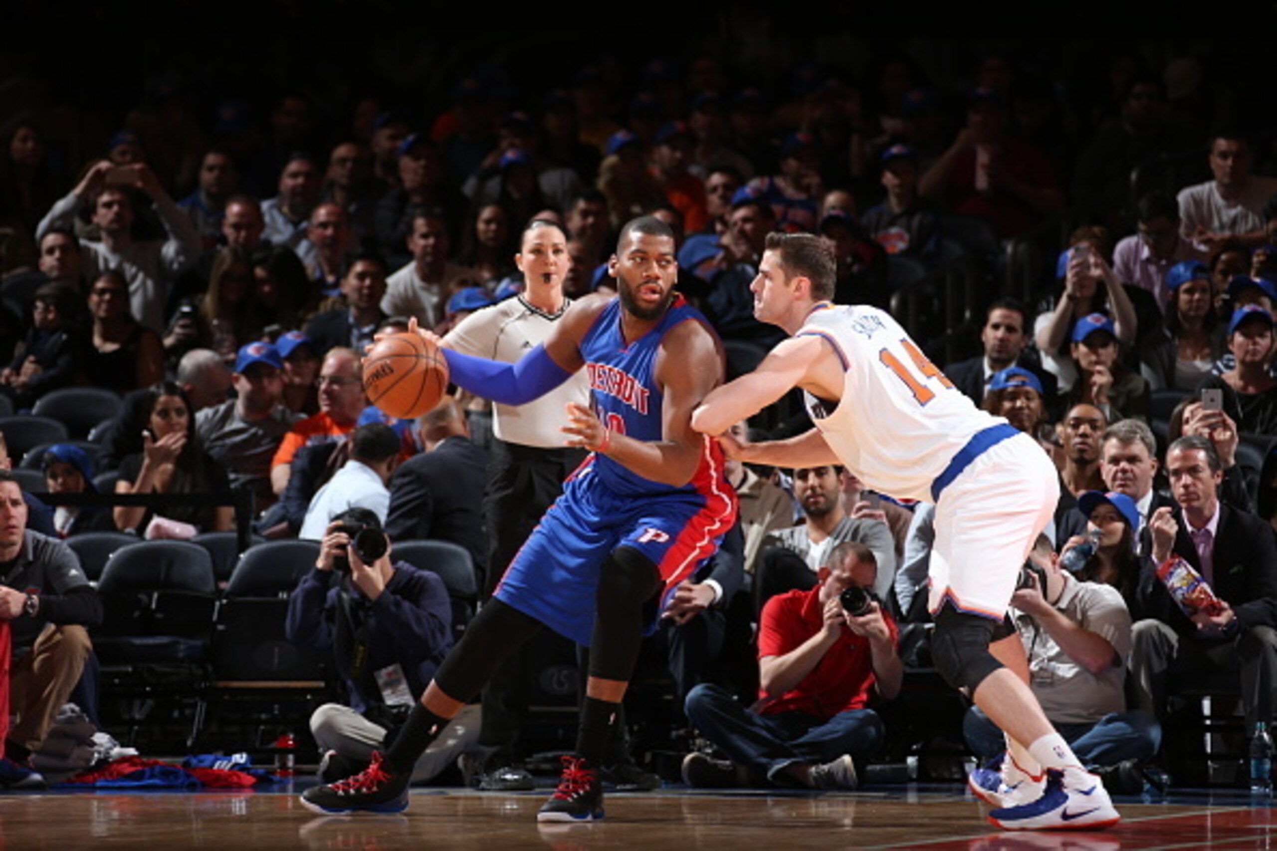 NEW YORK, NY - APRIL 15:  Greg Monroe #10 of the Detroit Pistons handles the ball against Jason Smith #14 of the New York Knicks on April 15, 2015 at Madison Square Garden in New York City.  NOTE TO USER: User expressly acknowledges and agrees that, by do