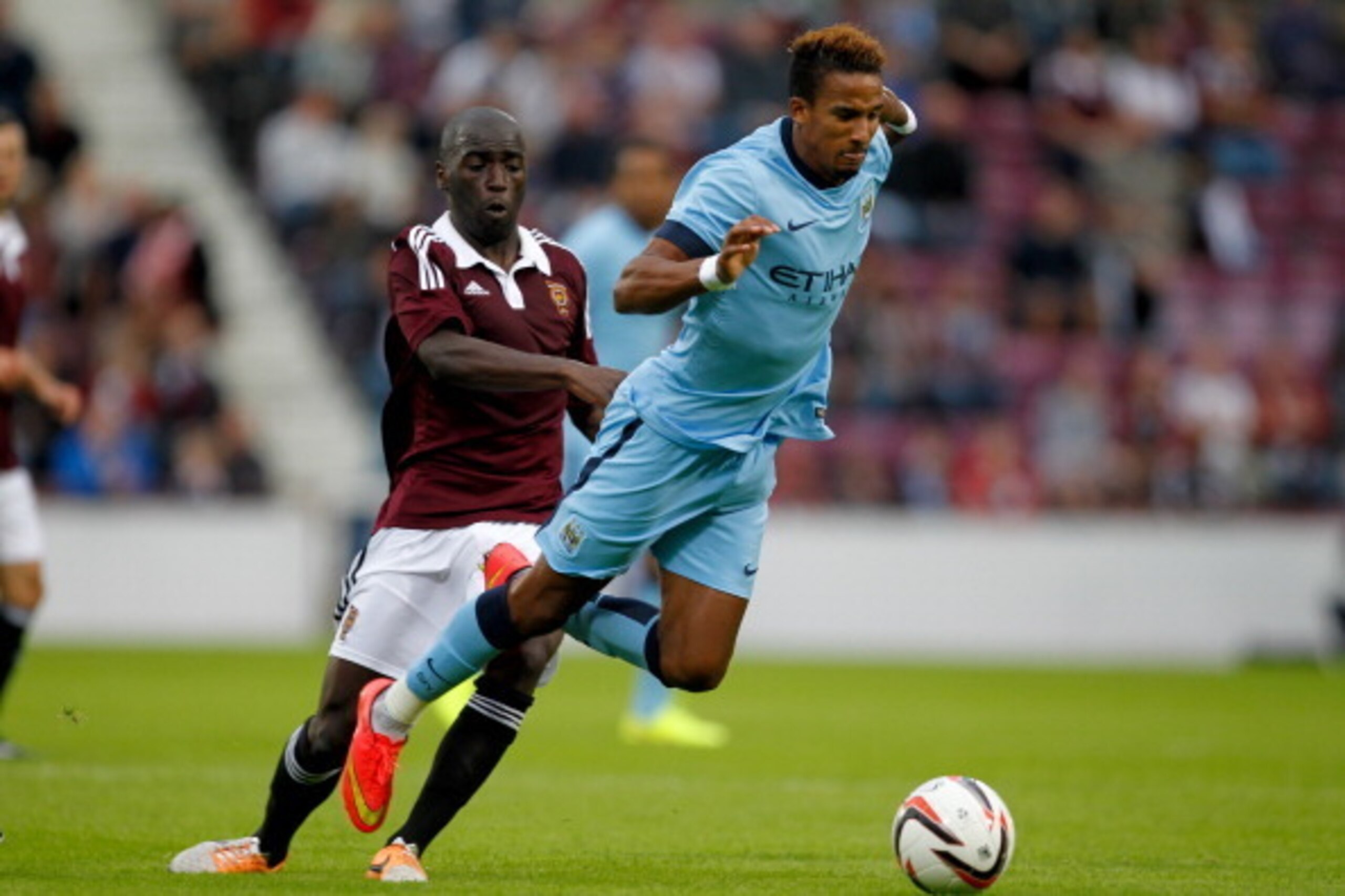 EDINBURGH, SCOTLAND - JULY 18: Morgaro Gomis of Heart of Midlothian tackes Scott Sinclair of Manchester City during the pre-season friendly at Tynecastle Stadium on July 18, 2014 in Edinburgh, Scotland. (Photo by Richard Sellers/Getty Images)