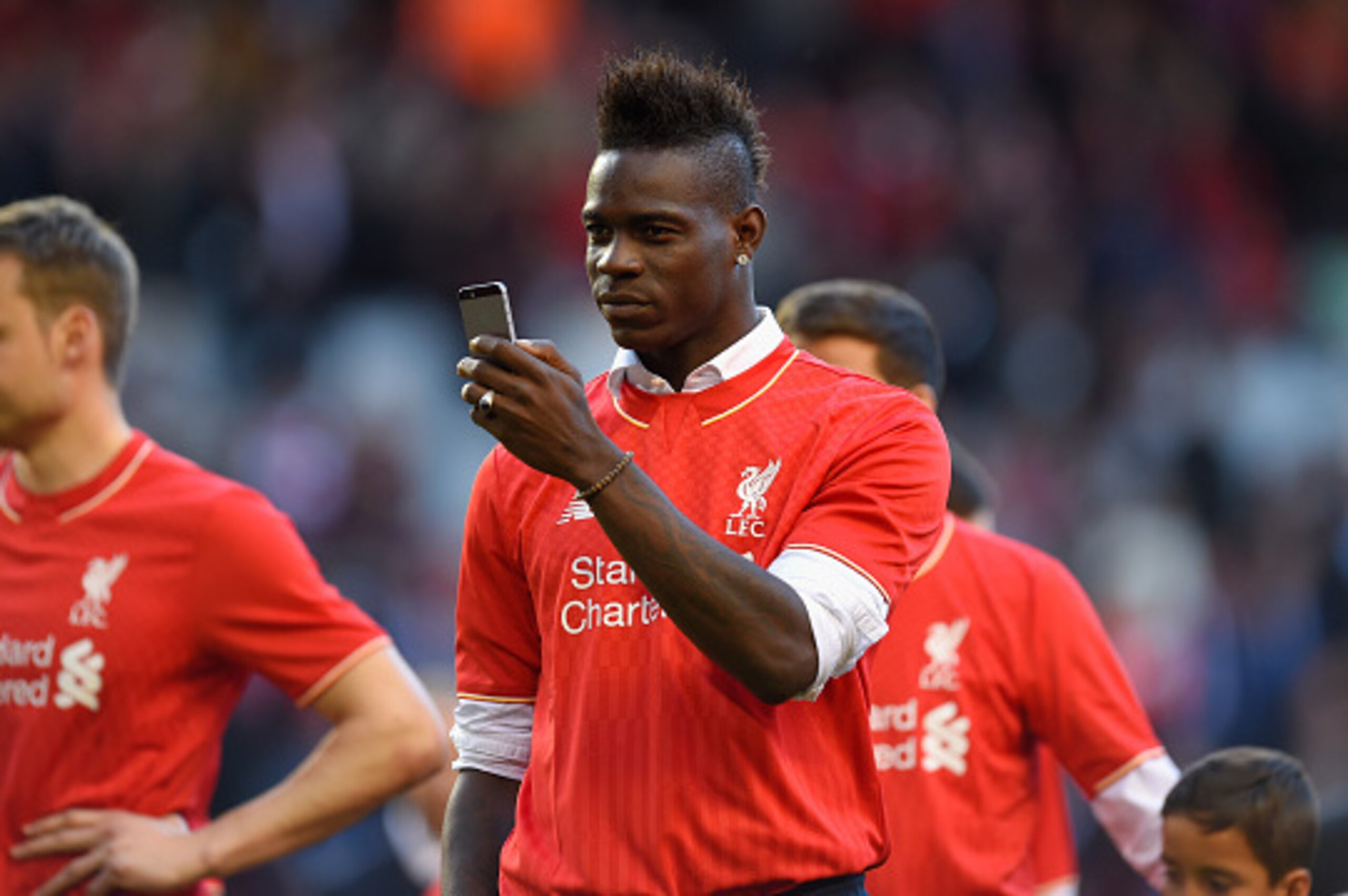 LIVERPOOL, ENGLAND - MAY 16:  Mario Balotelli of Liverpool takes pictures of the fans on his phone after the Barclays Premier League match betrween Liverpool and Crystal Palace at Anfield on May 16, 2015 in Liverpool, England.  (Photo by Stu Forster/Getty
