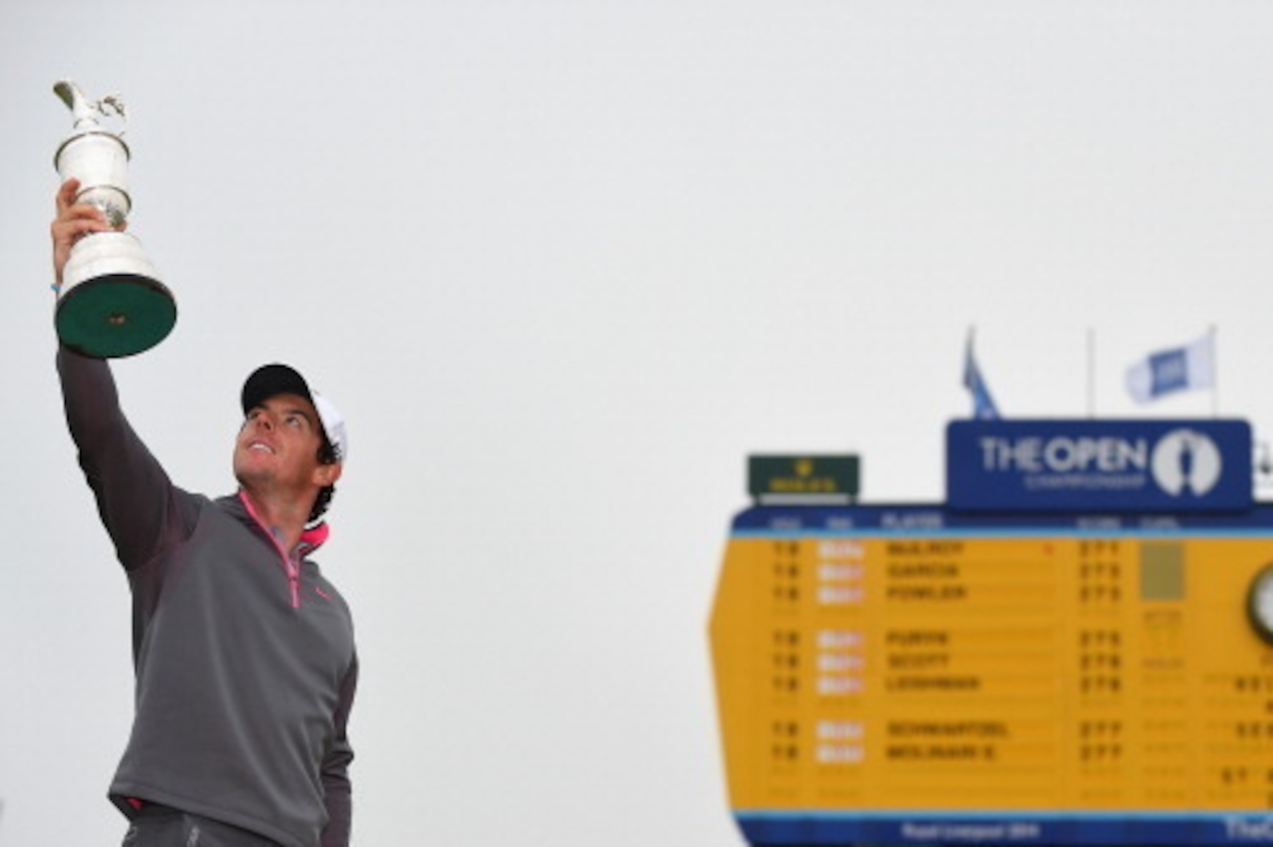 HOYLAKE, ENGLAND - JULY 20:  Rory McIlroy of Northern Ireland holds the Claret Jug aloft after his two-stroke victory at The 143rd Open Championship at Royal Liverpool on July 20, 2014 in Hoylake, England.  (Photo by Stuart Franklin/Getty Images)