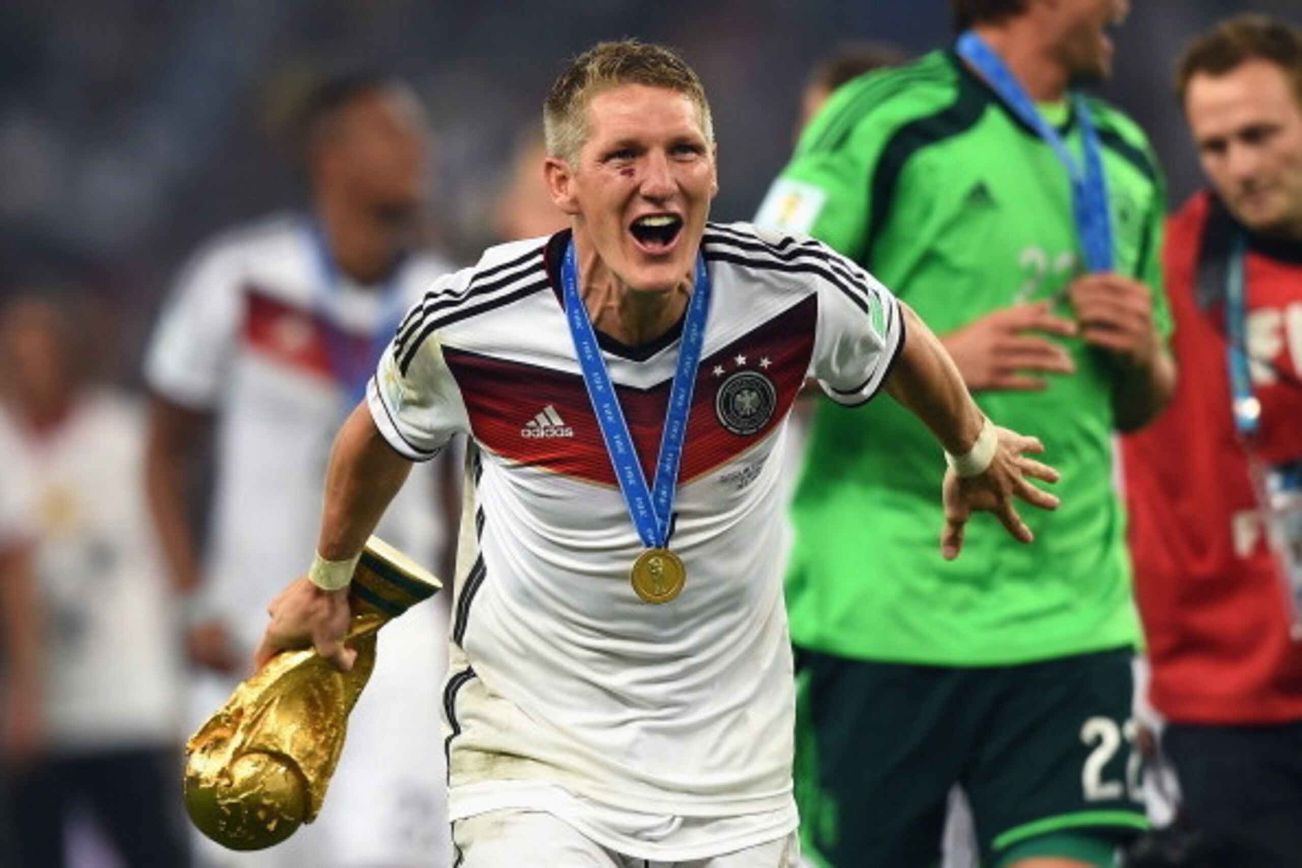 RIO DE JANEIRO, BRAZIL - JULY 13:  Bastian Schweinsteiger  of Germany celebrates with the World Cup trophy  after defeating Argentina 1-0 in extra time during the 2014 FIFA World Cup Brazil Final match between Germany and Argentina at Maracana on July 13,