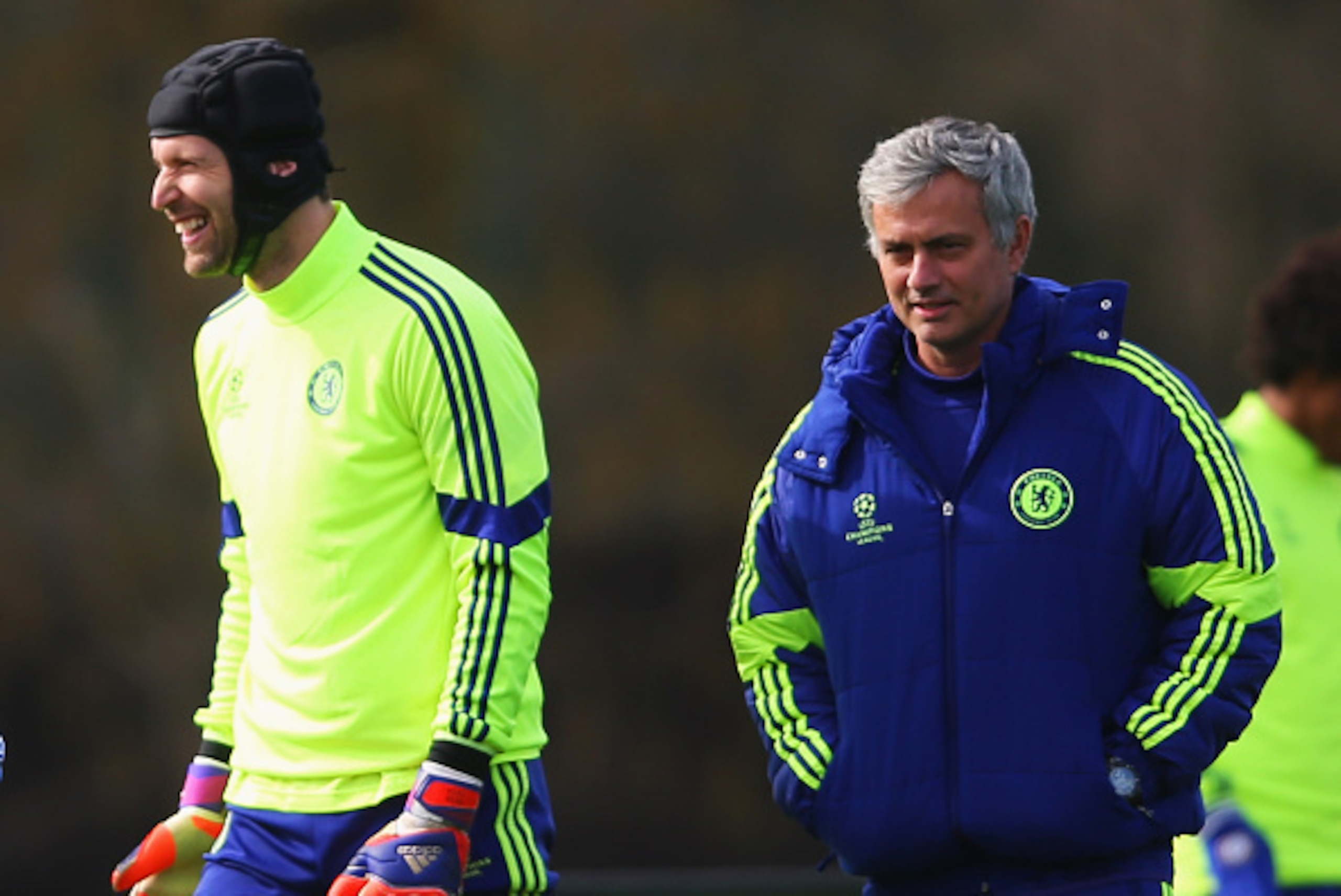 COBHAM, ENGLAND - MARCH 10:  Jose Mourinho manager of Chelsea (R) and goalkeeper Petr Cech (2R) smile during a Chelsea training session ahead of the UEFA Champions League Round of 16 second leg match against Paris Saint-Germain at Chelsea Training Ground 
