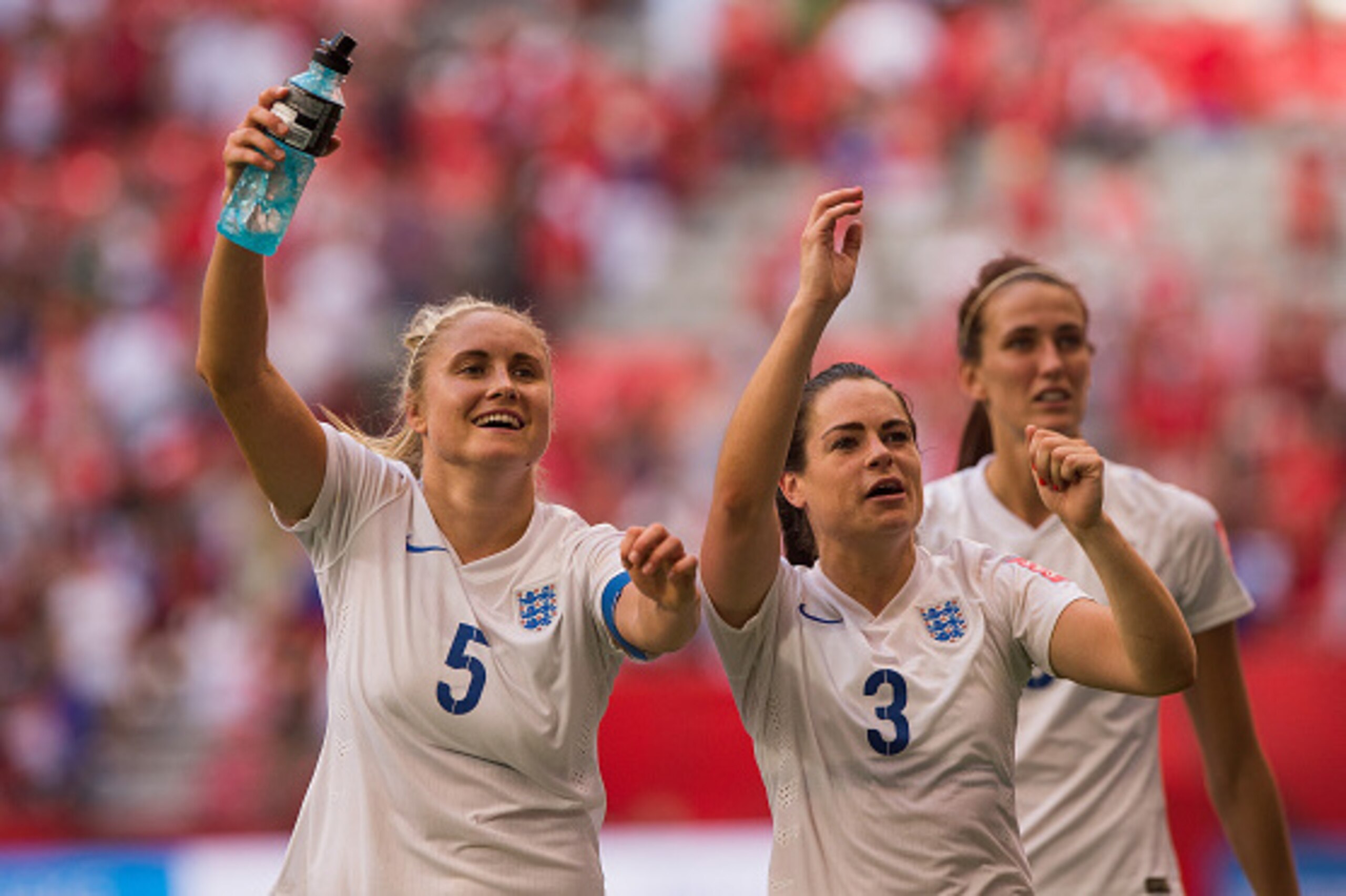 VANCOUVER, BC - JUNE 27: Steph Houghton #5 and Claire Rafferty #3 of England celebrate with fans after defeating Canada 2-1 in the FIFA Women's World Cup Canada 2015 Quarter Final match between the England and Canada June, 27, 2015 at BC Place Stadium in 