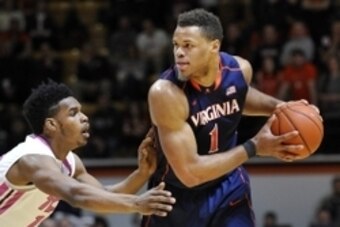 Jan 25, 2015; Blacksburg, VA, USA; Virginia Cavaliers guard Justin Anderson (1) looks to pass while being defended by Virginia Tech Hokies guard Ahmed Hill (13) in the first half at Cassell Coliseum. Virginia defeated Virginia Tech 50-47. Mandatory Credit