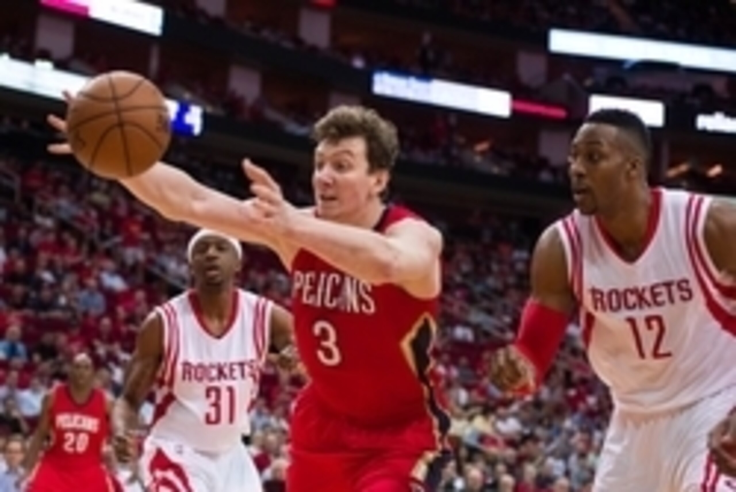 Apr 12, 2015; Houston, TX, USA; New Orleans Pelicans center Omer Asik (3) stretches for the loose ball as  Houston Rockets center Dwight Howard (12) looks on during the first quarter at the Toyota Center. Mandatory Credit: Jerome Miron-USA TODAY Sports