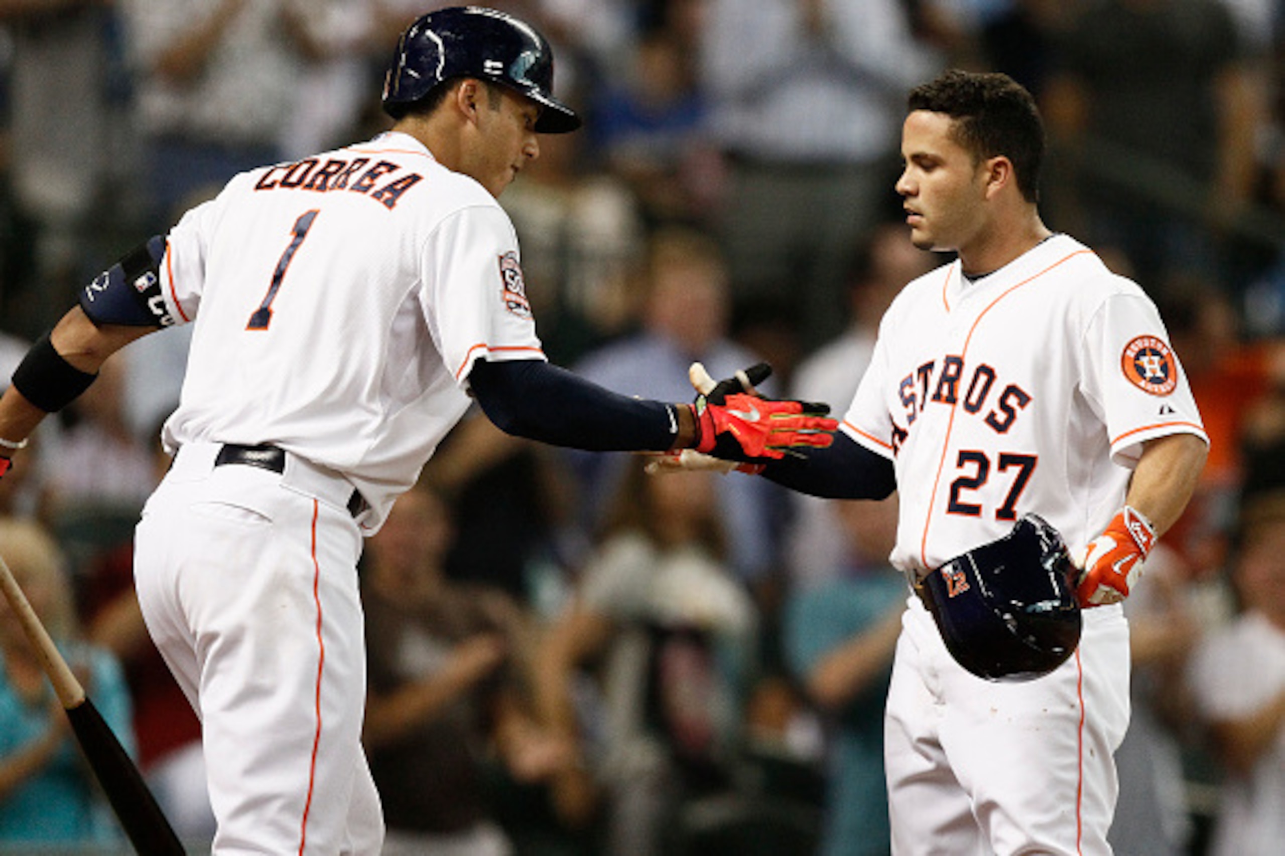 HOUSTON, TX - JUNE 29:  Jose Altuve #27 of the Houston Astros receives congratulations from Carlos Correa #1 after hitting a home run in the third inning against the Kansas City Royals at Minute Maid Park on June 29, 2015 in Houston, Texas.  (Photo by Bob