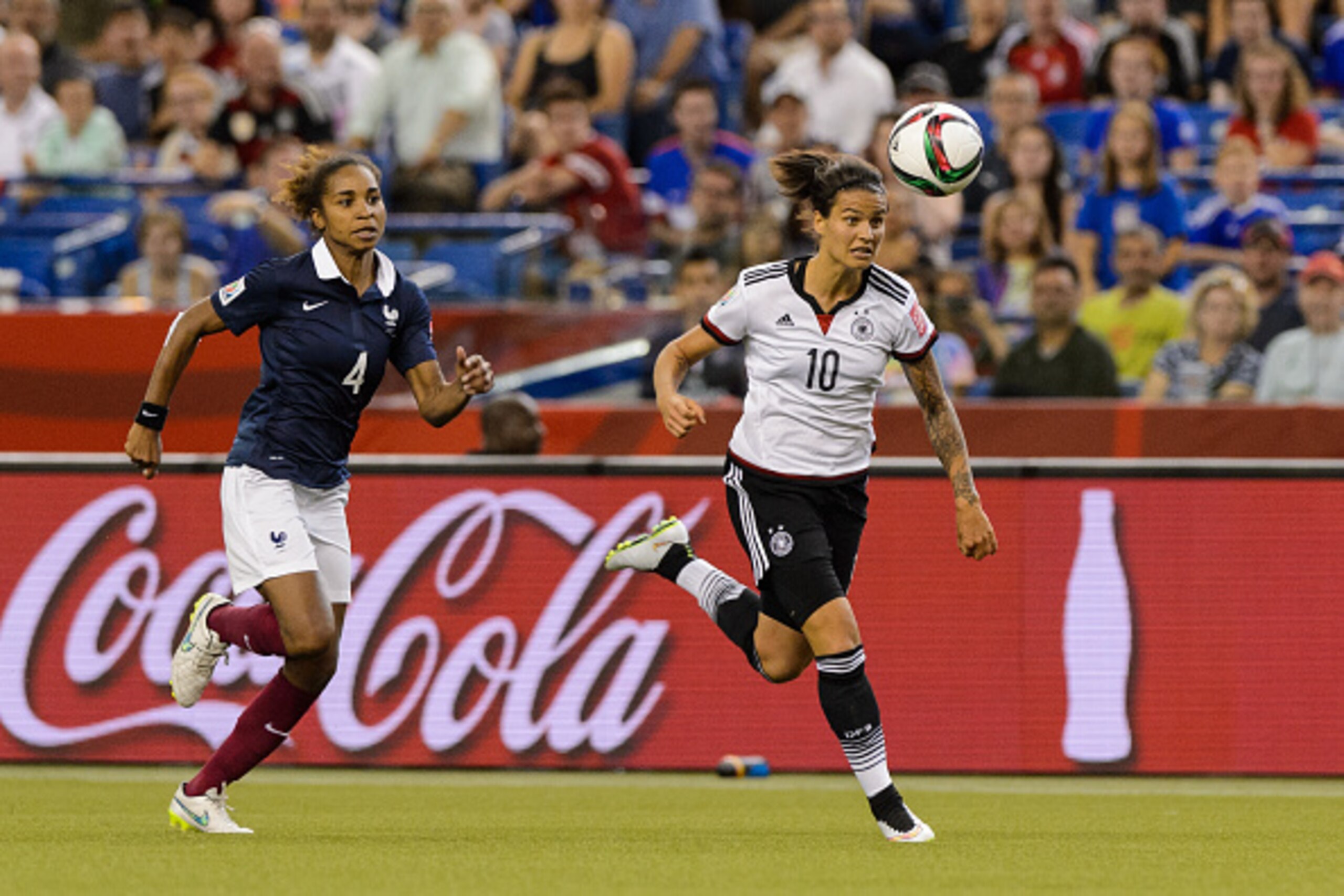 MONTREAL, QC - JUNE 26: Dzsenifer Marozsan #10 of Germany runs for the ball with Laura Georges #4 of France following close behind during the 2015 FIFA Women's World Cup quarter final match at Olympic Stadium on June 26, 2015 in Montreal, Quebec, Canada. 