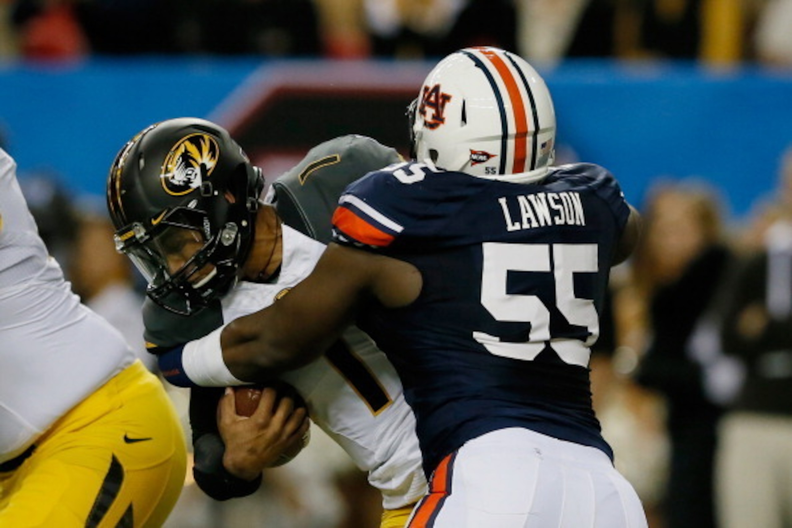 ATLANTA, GA - DECEMBER 07:  Carl Lawson #55 of the Auburn Tigers tackles quarterback James Franklin #1 of the Missouri Tigers in the second quarter during the SEC Championship Game at Georgia Dome on December 7, 2013 in Atlanta, Georgia.  (Photo by Kevin 