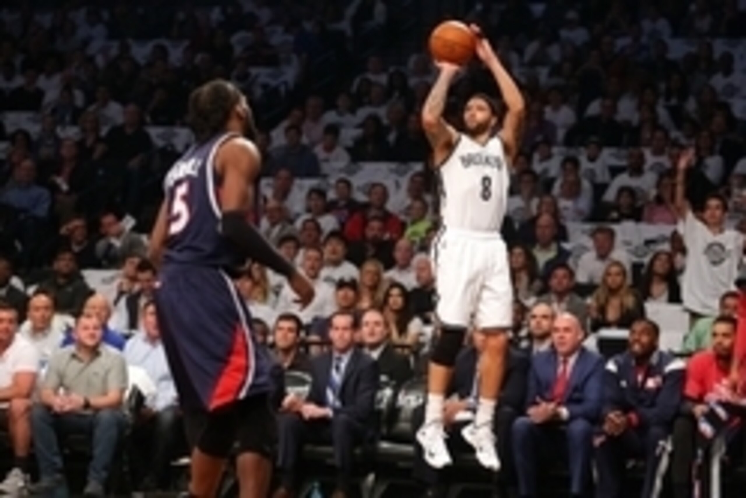 May 1, 2015; Brooklyn, NY, USA; Brooklyn Nets point guard Deron Williams (8) shoots over Atlanta Hawks small forward DeMarre Carroll (5) during the first quarter of game six of the first round of the NBA Playoffs at Barclays Center. Mandatory Credit: Brad