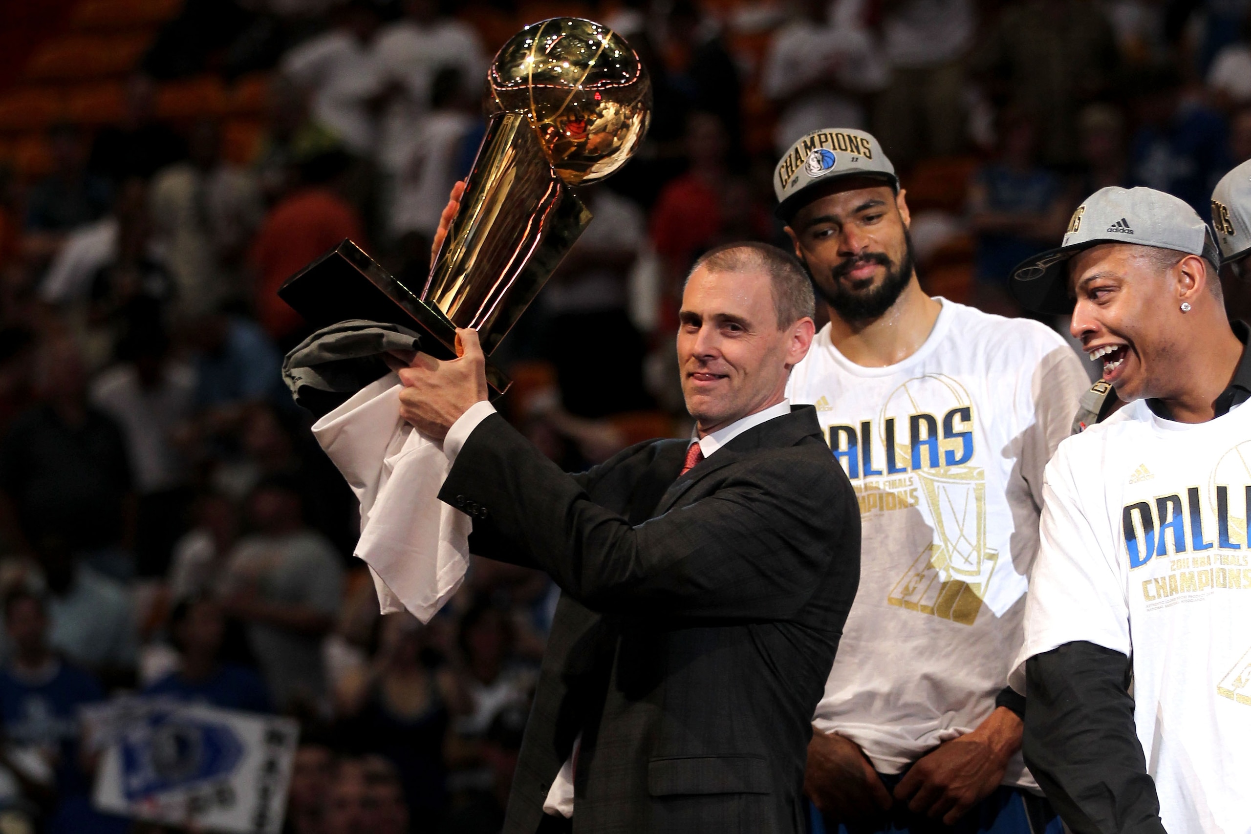 MIAMI, FL - JUNE 12:  Head coach Rick Carlisle of the Dallas Mavericks celebrates with the Larry O'Brien trophy as Tyson Chandler and Caron Butler (R) look on after they won 105-95 against the Miami Heat in Game Six of the 2011 NBA Finals at American Airl