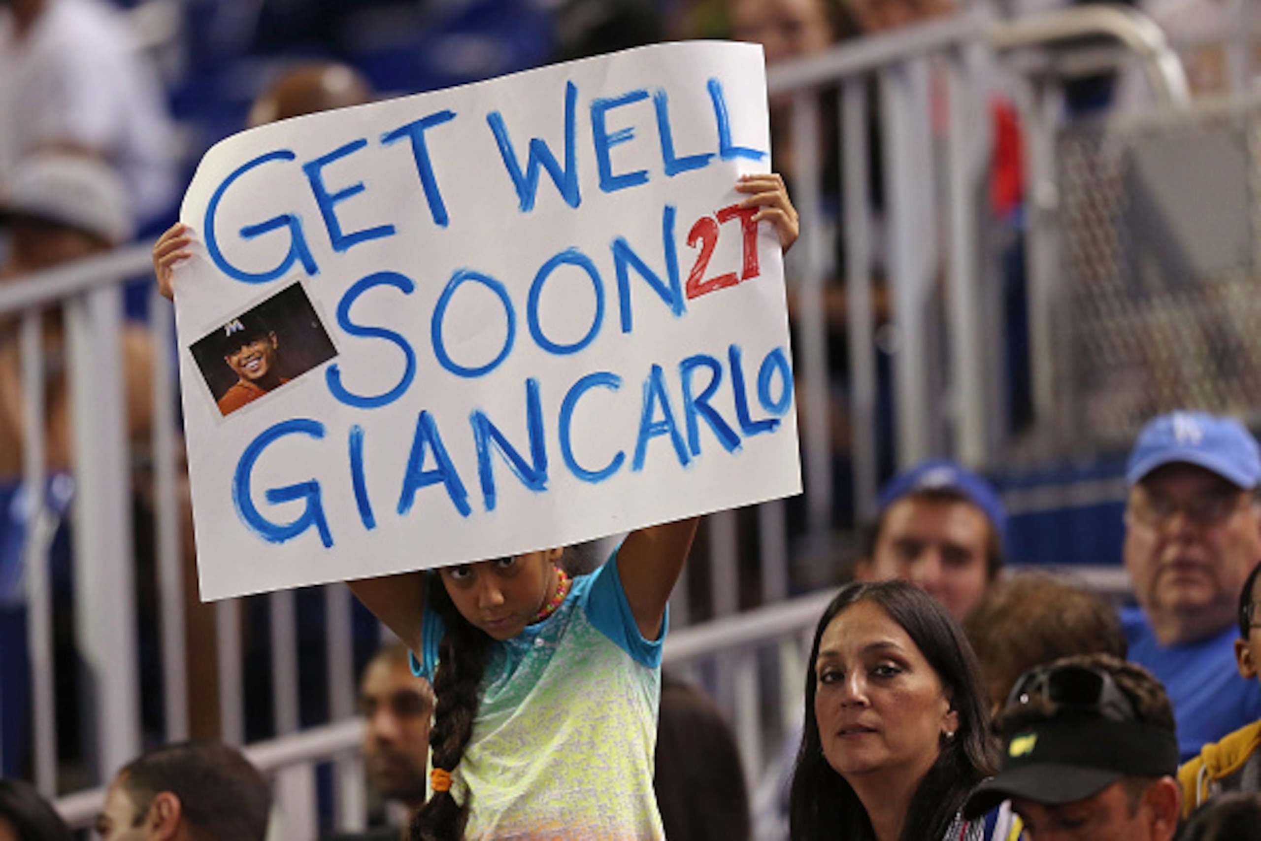 MIAMI, FL - JUNE 27: A fan holds a get well sign for injured Giancarlo Stanton in between innings of the game between the Miami Marlins and the Los Angeles Dodgers at Marlins Park on June 27, 2015 in Miami, Florida.  (Photo by Rob Foldy/Getty Images)