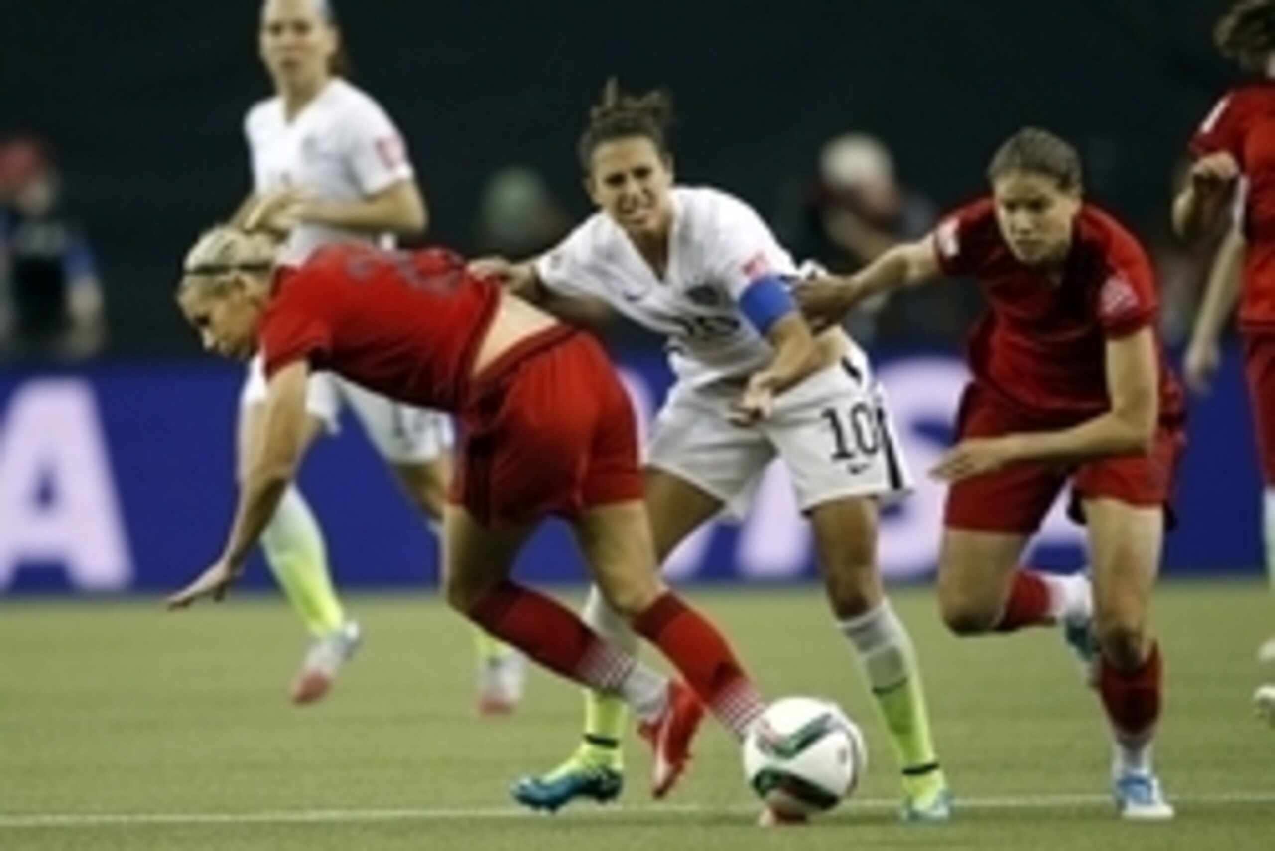 Jun 30, 2015; Montreal, Quebec, CAN; United States midfielder Carli Lloyd (10) competes for the ball against Germany midfielder Lena Goessling (20) and defender Annike Krahn (5) during the first half of the semifinals of the FIFA 2015 women's World Cup at