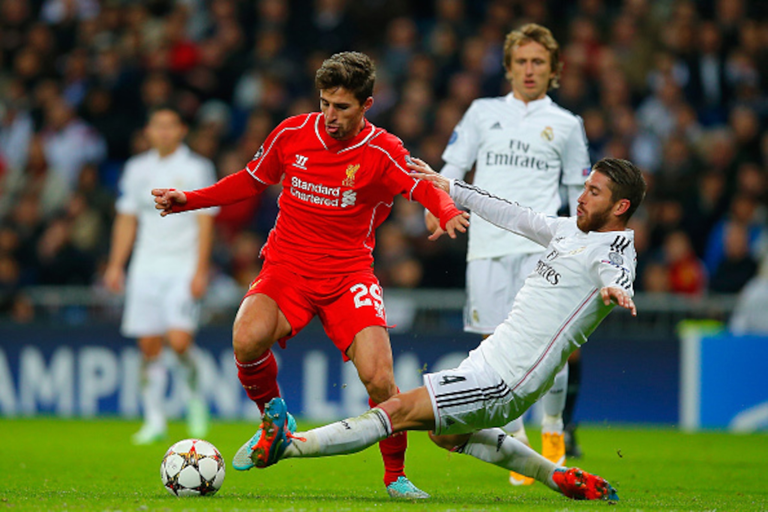 MADRID, SPAIN - NOVEMBER 04:  Sergio Ramos of Real Madrid CF tackles Fabio Borini of Liverpool during the UEFA Champions League Group B match between Real Madrid CF and Liverpool FC at Estadio Santiago Bernabeu on November 4, 2014 in Madrid, Spain.  (Phot