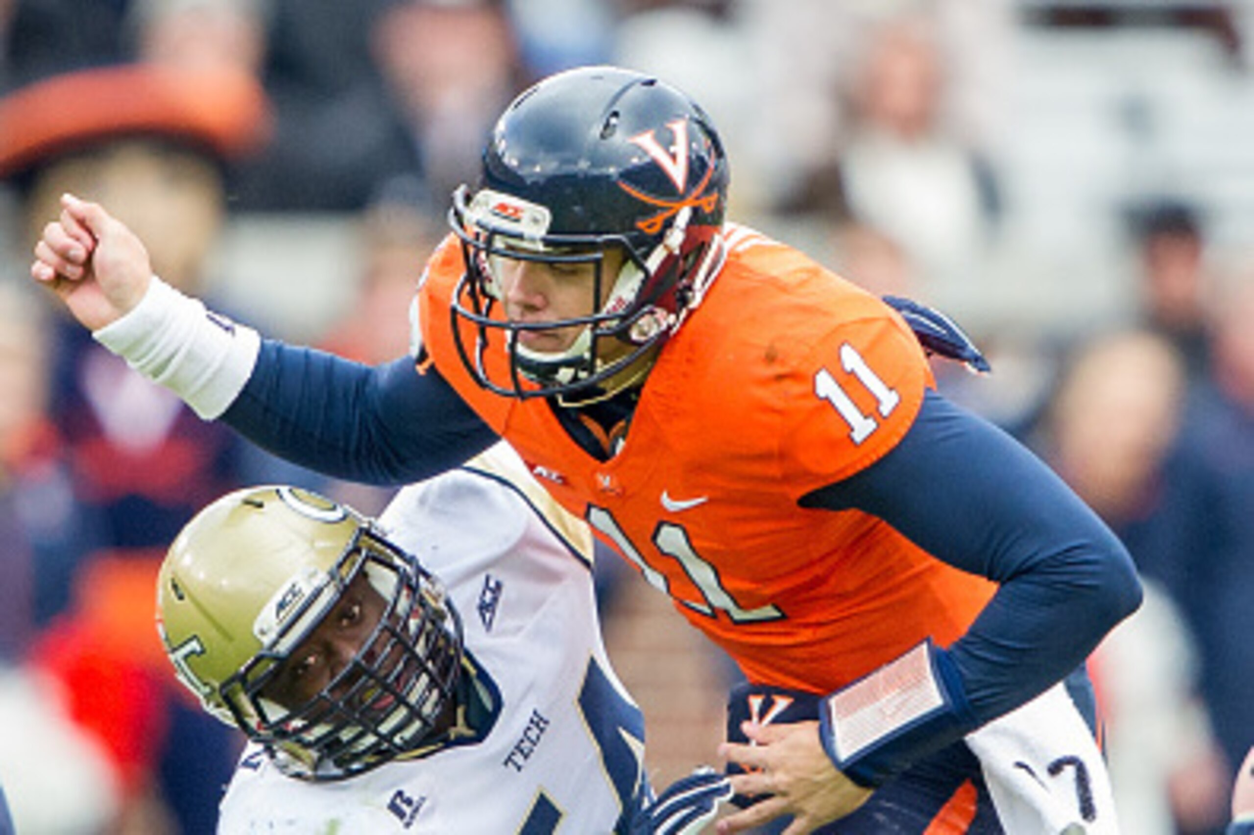 ATLANTA, GA - NOVEMBER 1: Linebacker Quayshawn Nealy #54 of the Georgia Tech Yellow Jackets hits quarterback Greyson Lambert #11 of the Virginia Cavaliers on November 1, 2014 at Bobby Dodd Stadium in Atlanta, Georgia. At halftime the Georgia Tech Yellow J