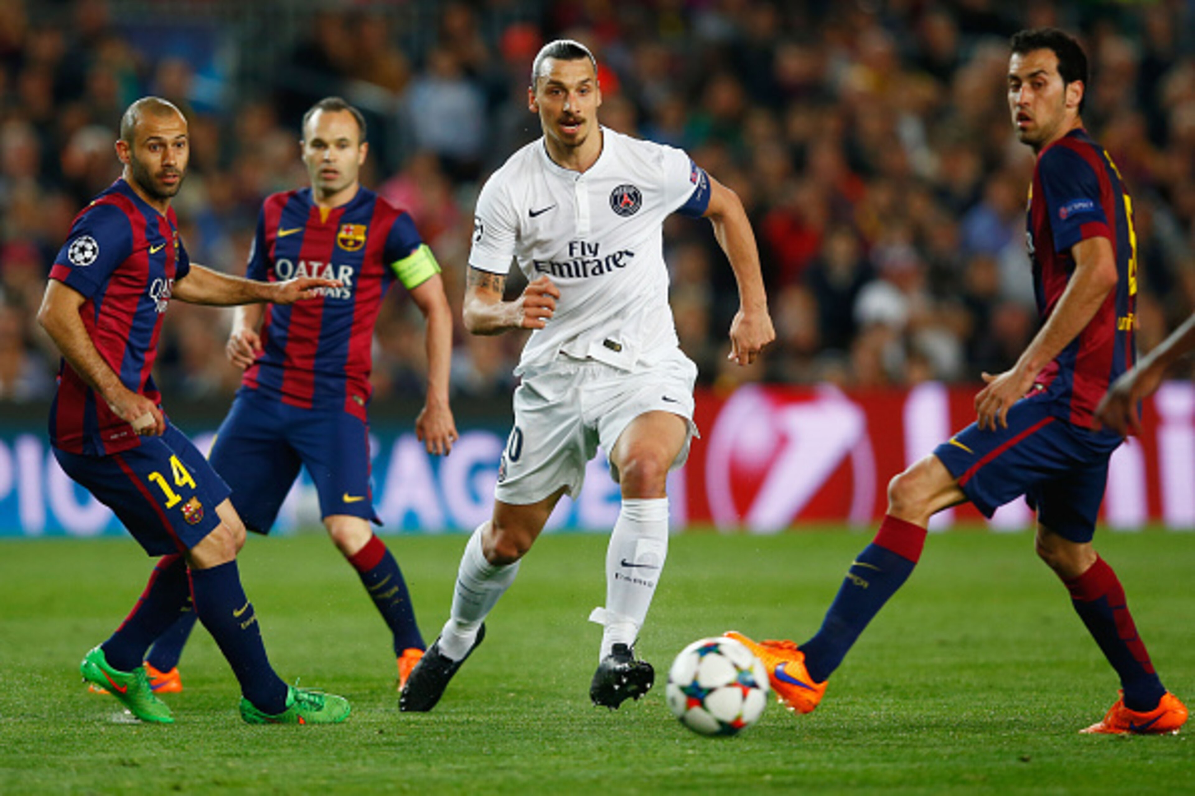 BARCELONA, SPAIN - APRIL 21:  Zlatan Ibrahimovic of PSG takes on Javier Mascherano, Andres Iniesta and Sergio Busquets of Barcelona during the UEFA Champions League Quarter Final second leg match between FC Barcelona and Paris Saint-Germain at Camp Nou on