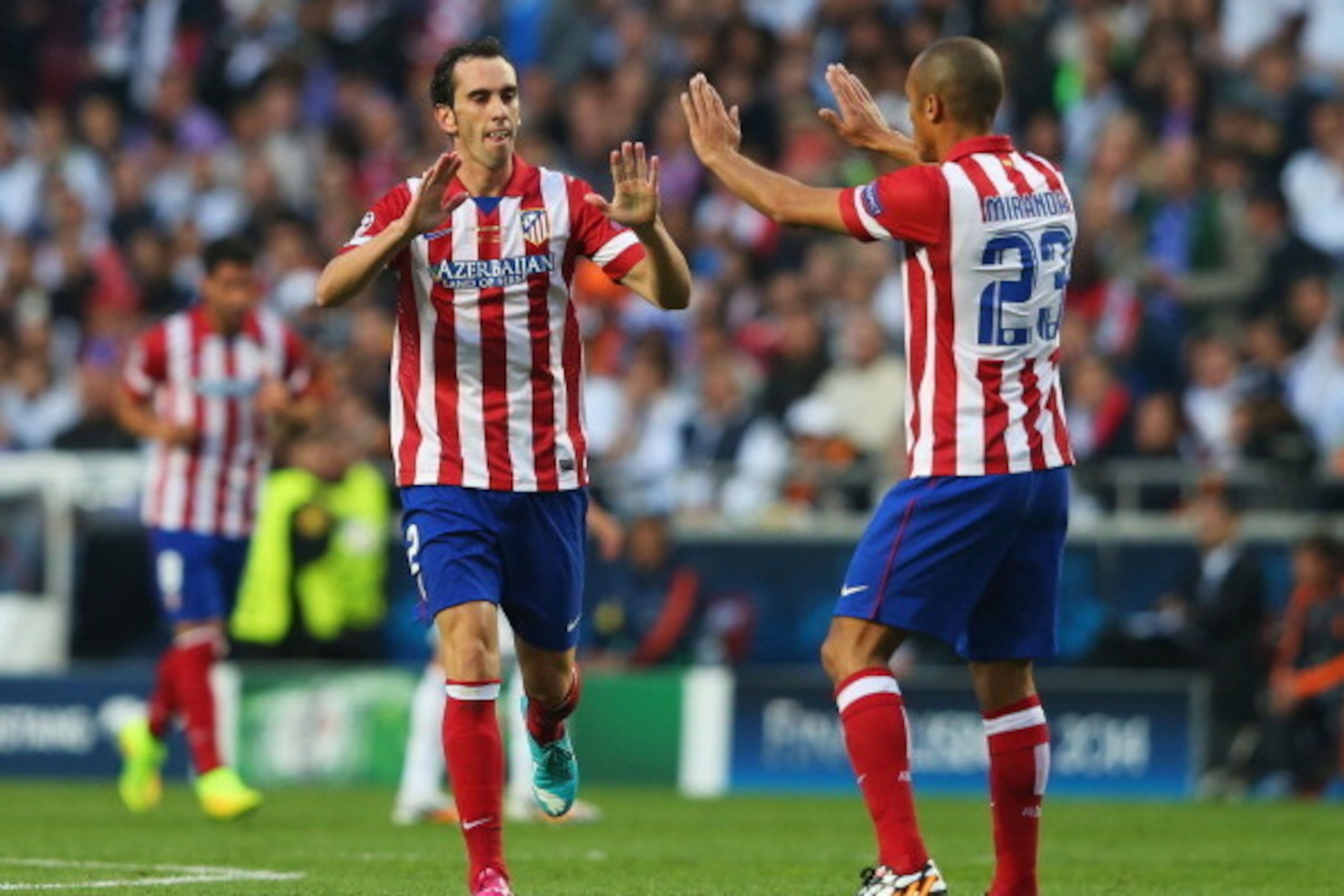 LISBON, PORTUGAL - MAY 24:  Diego Godin of Club Atletico de Madrid is congratulated on scoring the first goal by Miranda of Club Atletico de Madrid during the UEFA Champions League Final between Real Madrid and Atletico de Madrid at Estadio da Luz on May 
