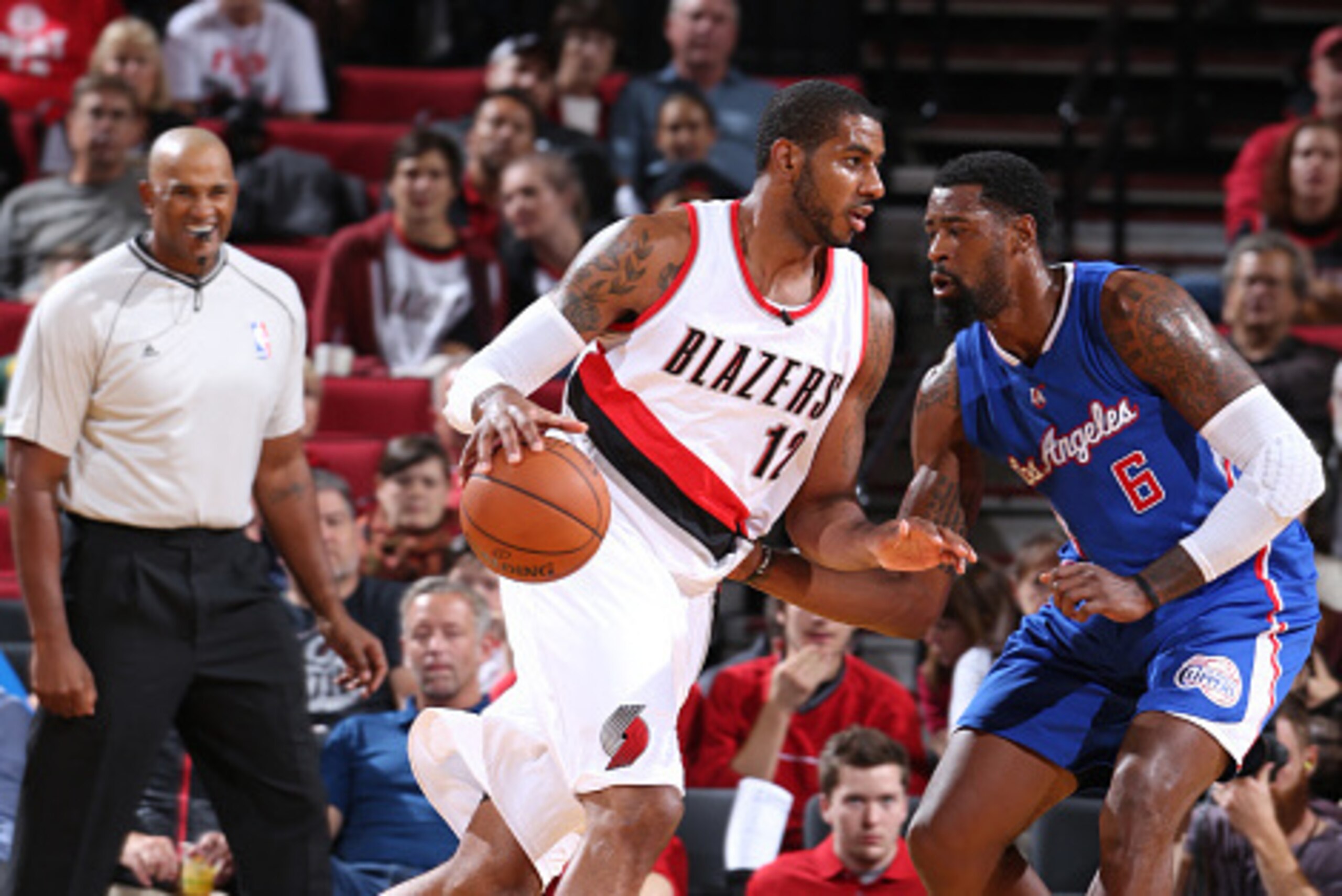 PORTLAND, OR - OCTOBER 12:  LaMarcus Aldridge #12 of the Portland Trail Blazers handles the ball against DeAndre Jordan #6 of the Los Angeles Clippers on October 12, 2014 at the Moda Center Arena in Portland, Oregon. NOTE TO USER: User expressly acknowled