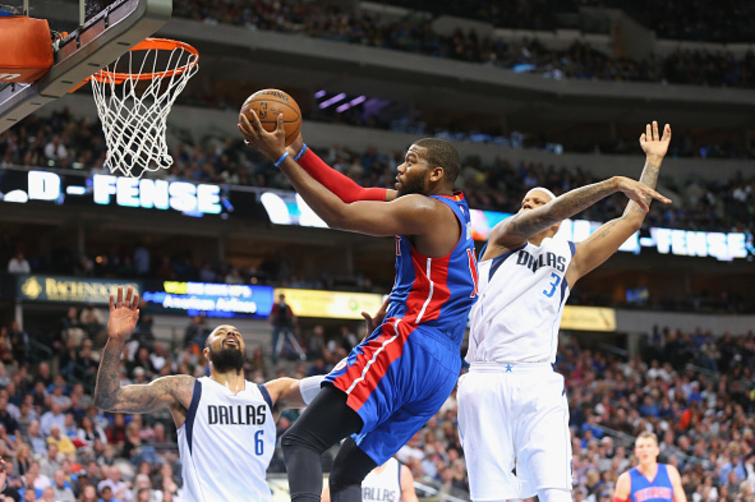 DALLAS, TX - JANUARY 07:  Greg Monroe #10 of the Detroit Pistons takes a shot against Charlie Villanueva #3 of the Dallas Mavericks at American Airlines Center on January 7, 2015 in Dallas, Texas.   NOTE TO USER: User expressly acknowledges and agrees tha