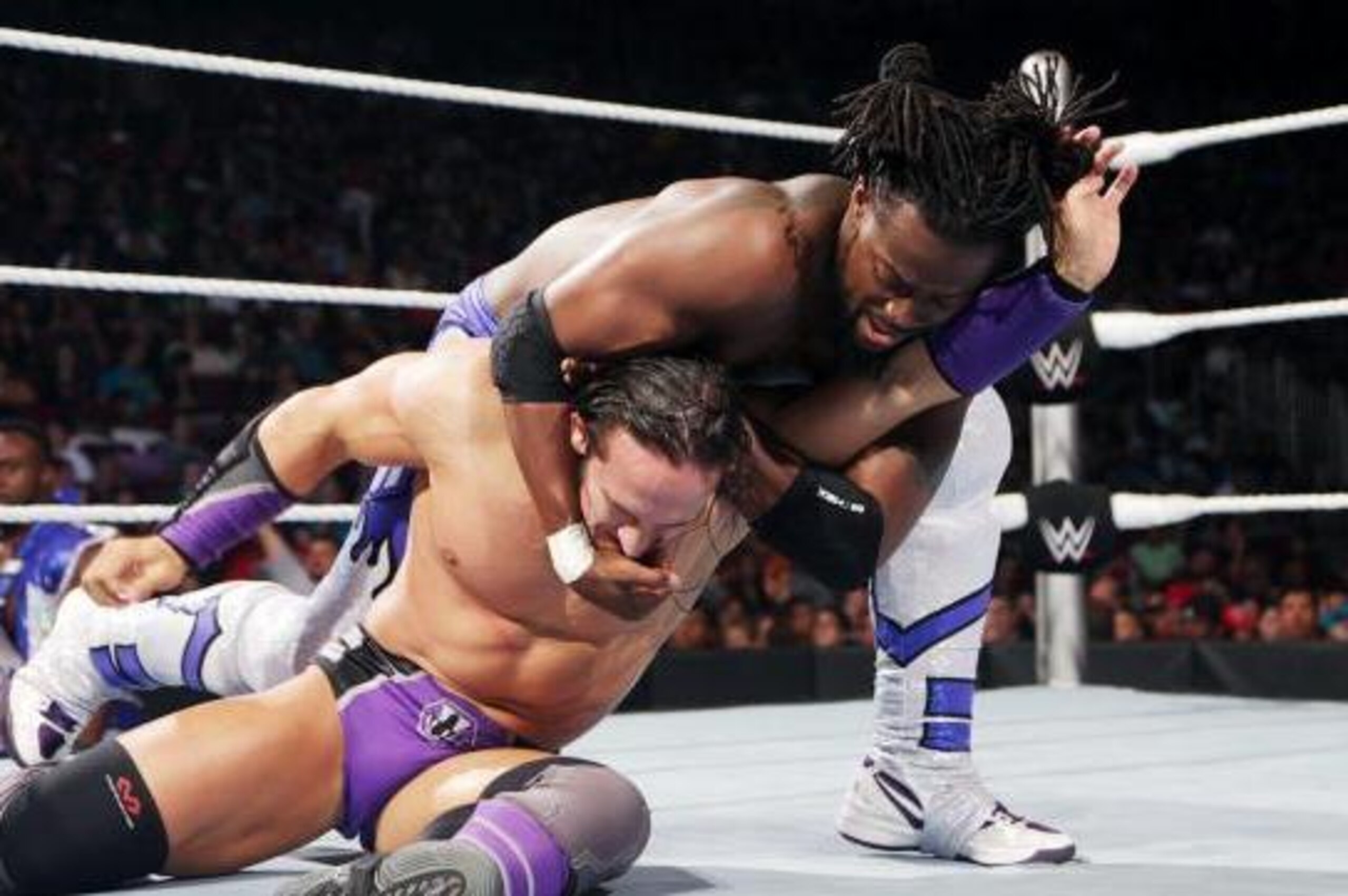 Kofi Kingston grabs hold of Neville. Kofi Kingston grabs hold of Neville.