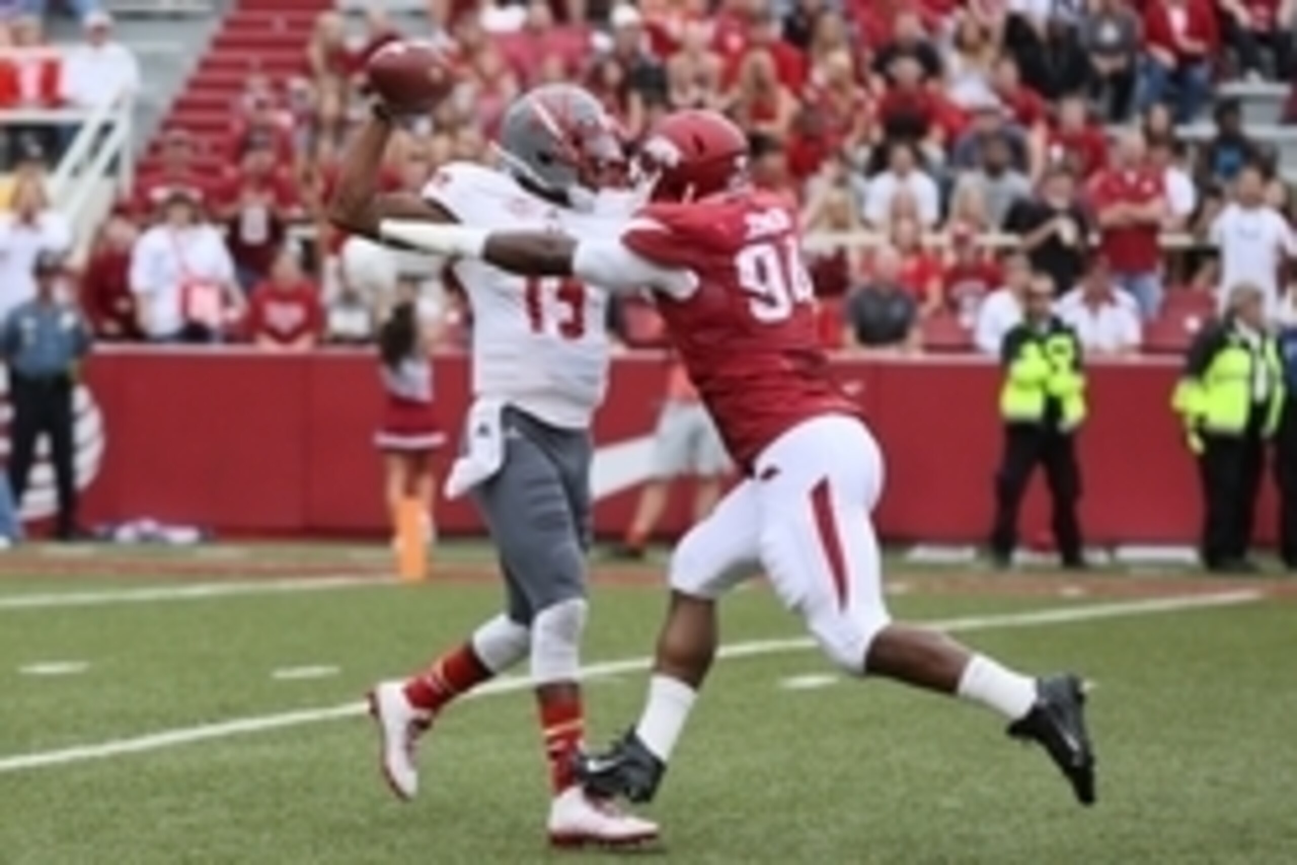 Sep 6, 2014; Fayetteville, AR, USA; Nicholls State Colonels quarterback Kalen Henderson (15) is pressured by Arkansas Razorbacks defensive tackle Taiwan Johnson (94) during the first quarter at Donald W. Reynolds Razorback Stadium. Mandatory Credit: Nelso