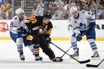 PITTSBURGH, PA - NOVEMBER 26:  Evgeni Malkin #71 of the Pittsburgh Penguins moves the puck in front of the defense of Phil Kessel #81 and Tyler Bozak #42 of the Toronto Maple Leafs at Consol Energy Center on November 26, 2014 in Pittsburgh, Pennsylvania. 