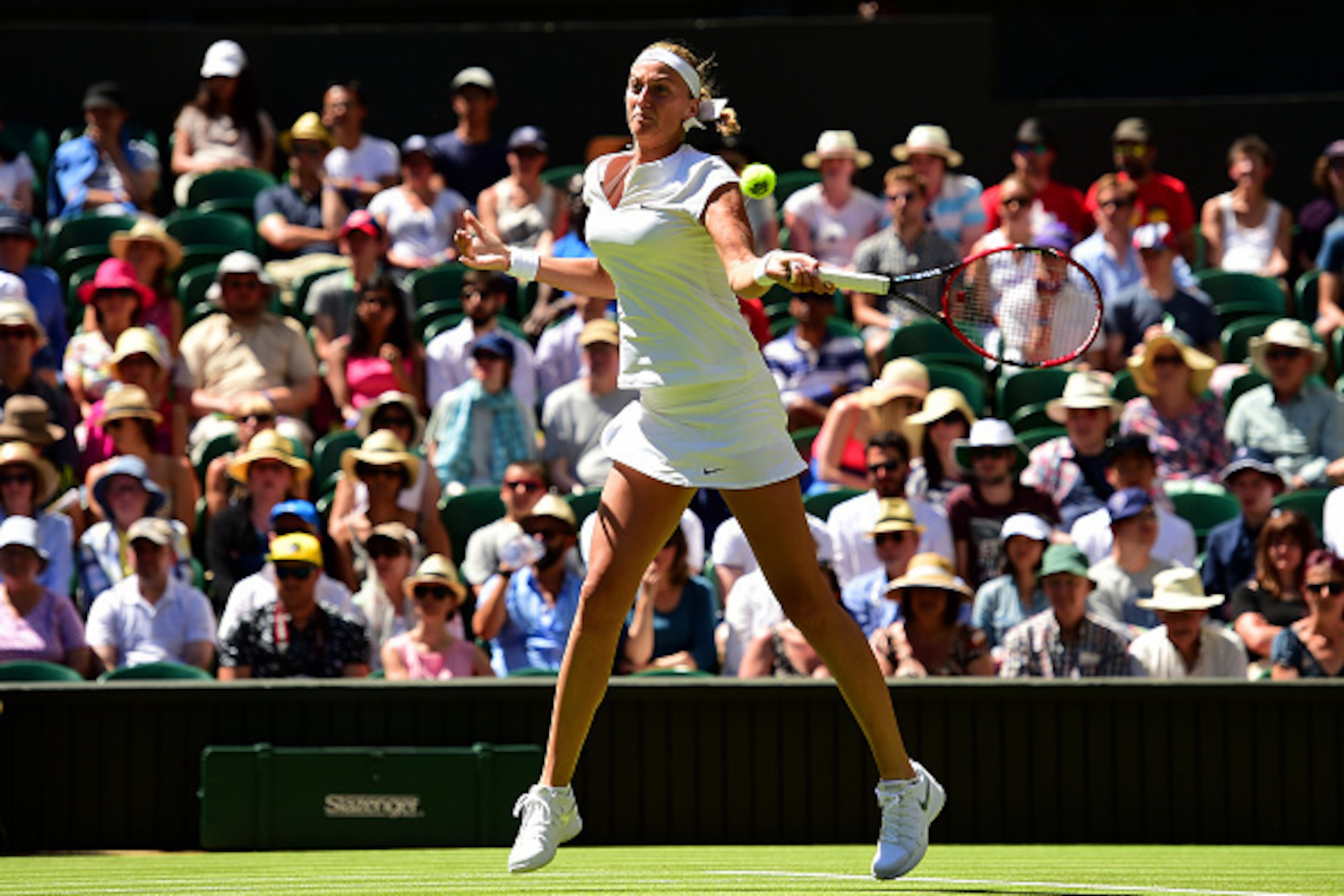 LONDON, ENGLAND - JUNE 30: Petra Kvitova of Czech Republic plays a forehand in her Ladies Singles first round match against Kiki Bertens of Netherlands during day two of the Wimbledon Lawn Tennis Championships at the All England Lawn Tennis and Croquet C LONDON, ENGLAND - JUNE 30: Petra Kvitova of Czech Republic plays a forehand in her Ladies Singles first round match against Kiki Bertens of Netherlands during day two of the Wimbledon Lawn Tennis Championships at the All England Lawn Tennis and Croquet C