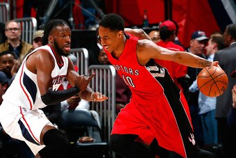 ATLANTA, GA - FEBRUARY 20:  DeMar DeRozan #10 of the Toronto Raptors drives against DeMarre Carroll #5 of the Atlanta Hawks at Philips Arena on February 20, 2015 in Atlanta, Georgia.  NOTE TO USER: User expressly acknowledges and agrees that, by downloadi