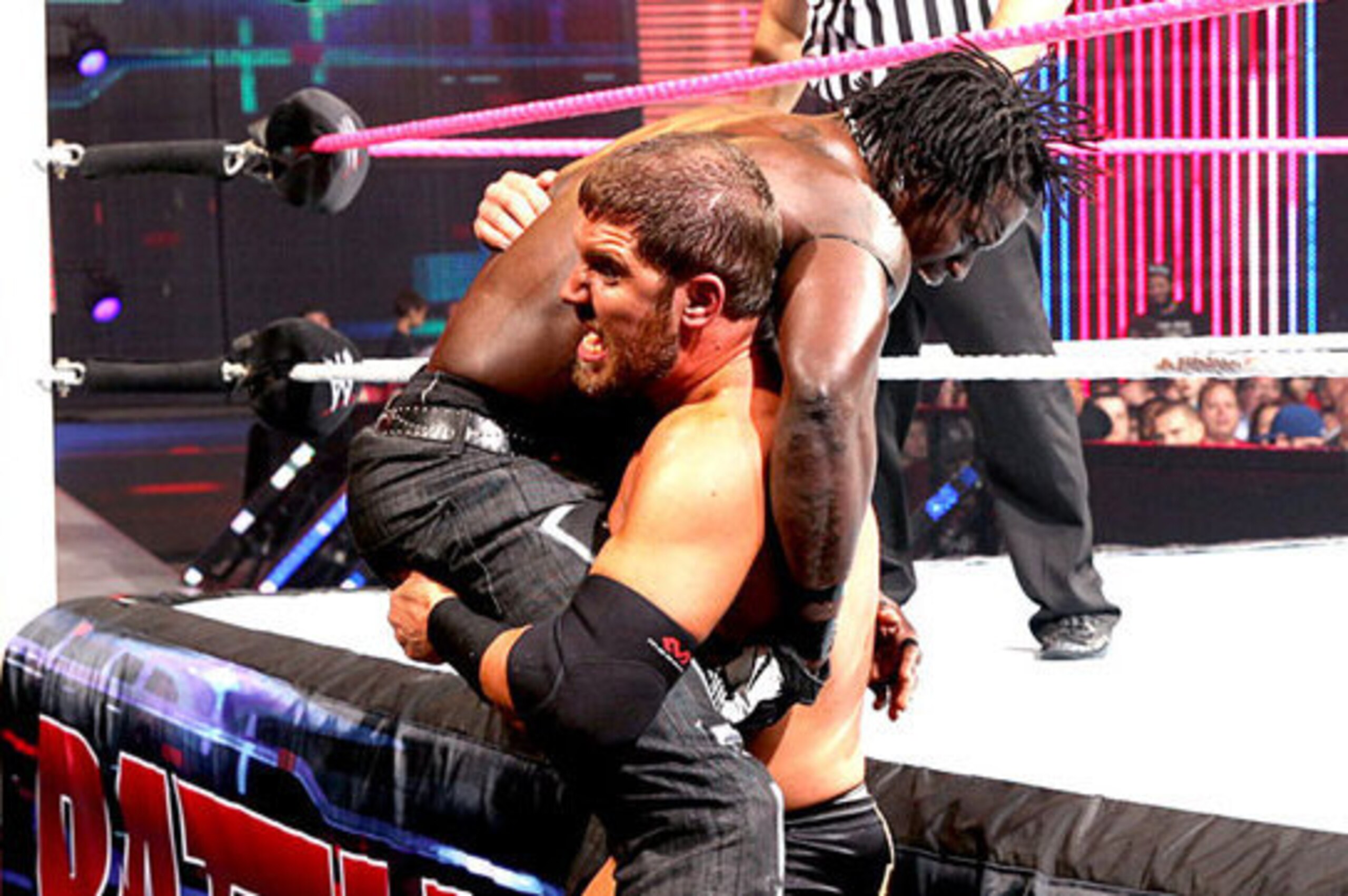 Curtis Axel lifts R-Truth.