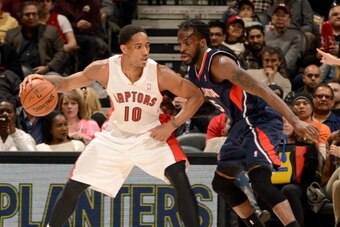 TORONTO, CANADA - March 23: DeMar DeRozan #10 of the Toronto Raptors handles the ball against DeMarre Carroll #5 of the Atlanta Hawks on March 23, 2014 at the Air Canada Centre in Toronto, Ontario, Canada.  NOTE TO USER: User expressly acknowledges and ag